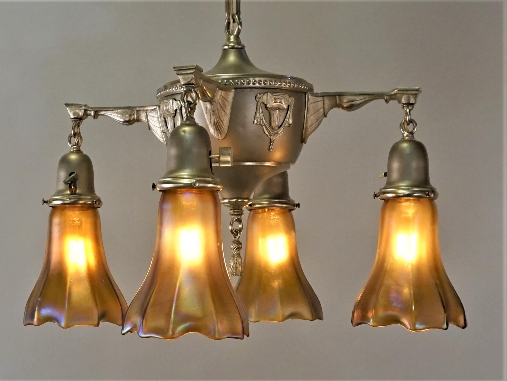 Elegant 1920s polished and stain finish brass chandelier with art glass shades.