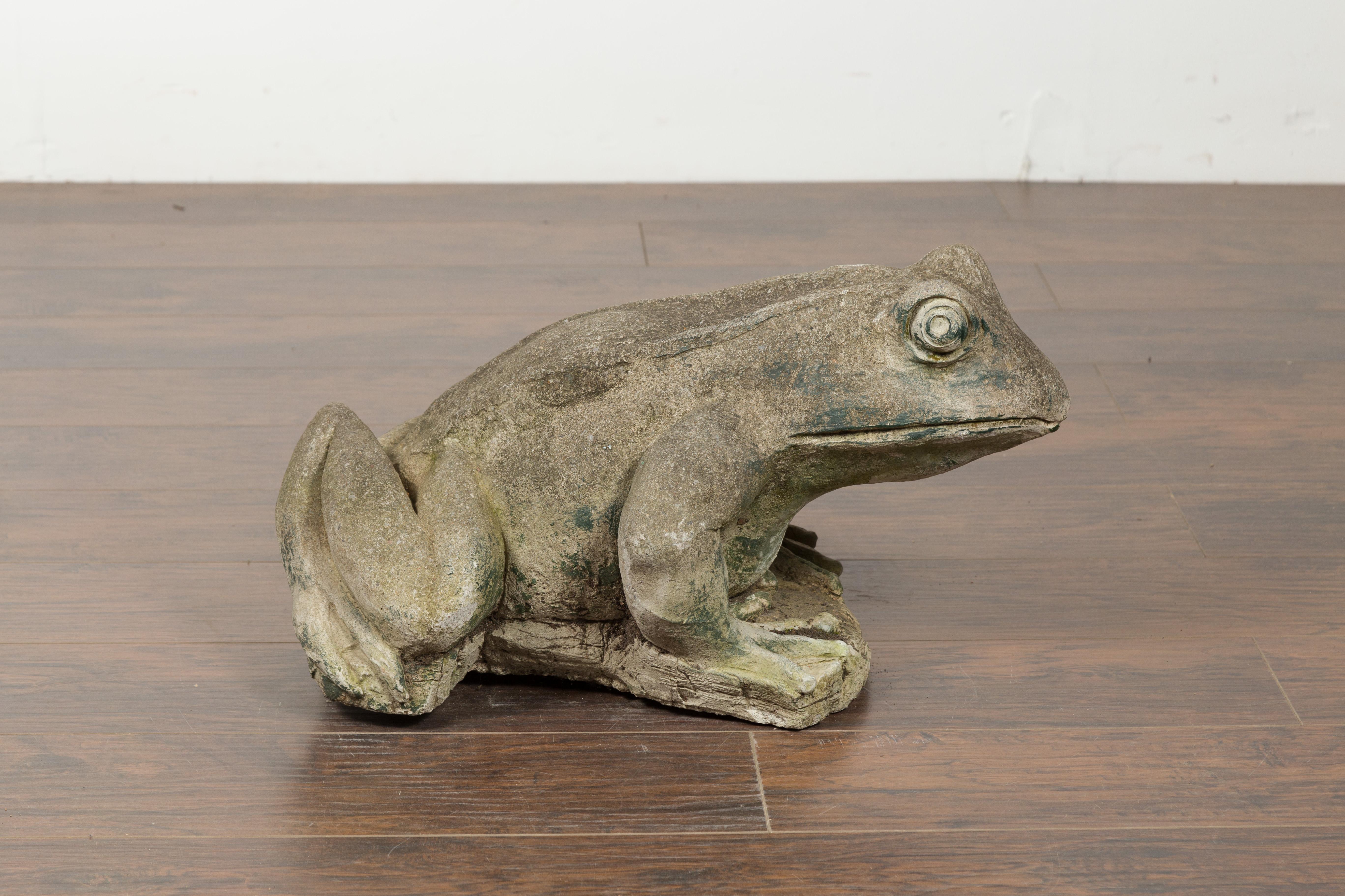 An American giant stone frog from the 20th century, with great patina. Made in the USA in 1987, this giant stone stone frog used to be a fountain (notice the remnants of a pipe below). The date is carved on the side of the base.The frog, depicted