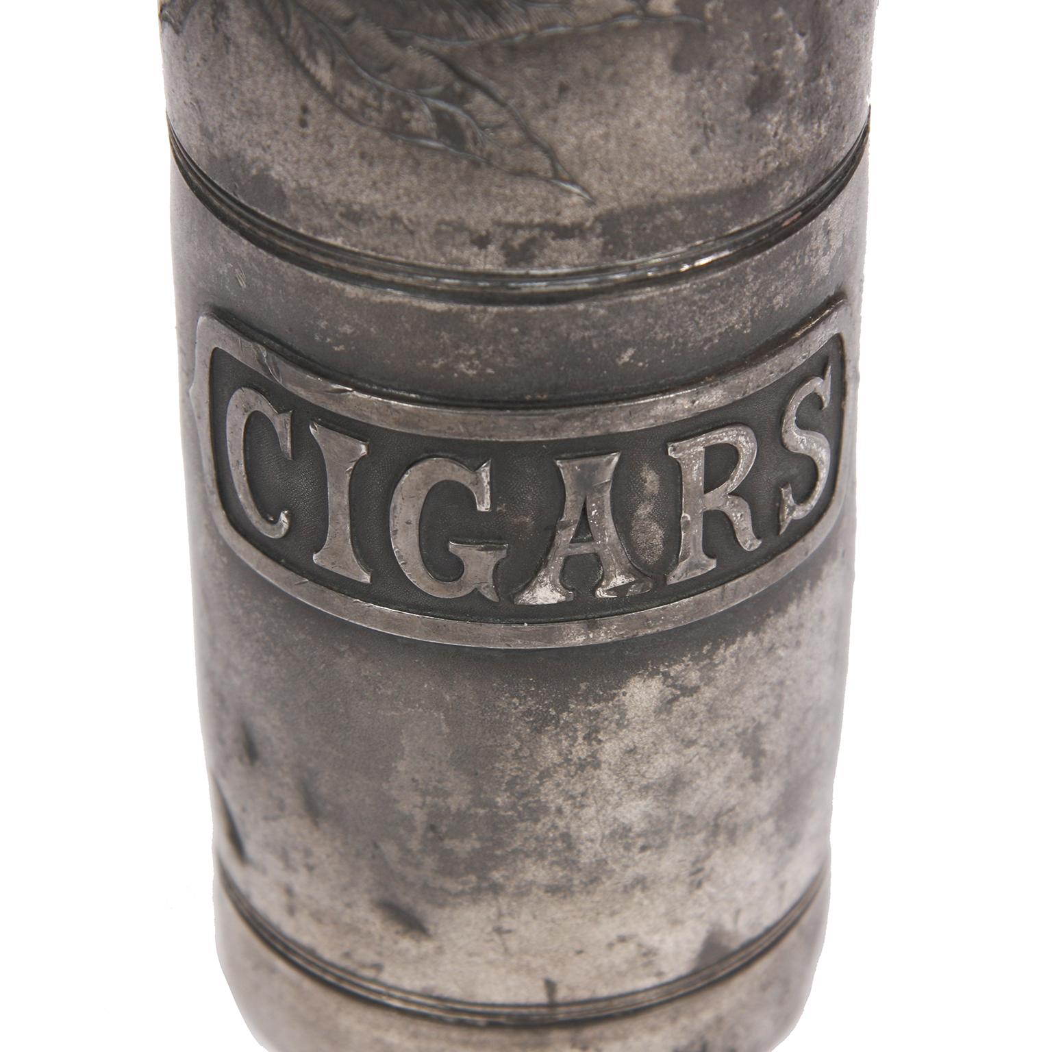 American 1920s

A silver plated, American 1920s, cigar holder in the shape of a Champagne bottle.
Well patinated silver plate. Very Gatsby-esque! 
Wonderful detail to the top, with an engraved tobacco leaf. 
Match striker on the reverse body.