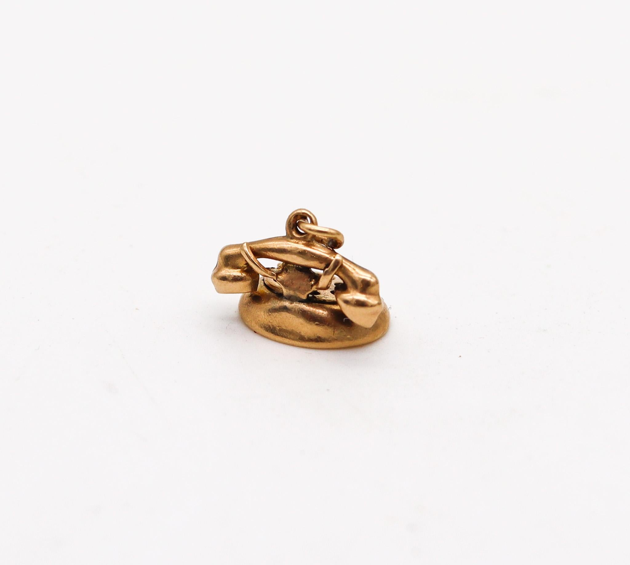 An American charm from the deco-retro period.

Here and in the following six lots, we are presenting an amazing selection of vintage charms for bracelets. This charm was made in America during the late art deco and the retro periods, before and