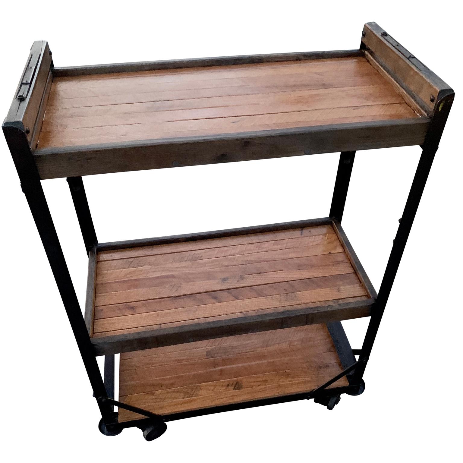 American 1960s wooden shelves, carts or bread racks on industrial iron wheels.
 