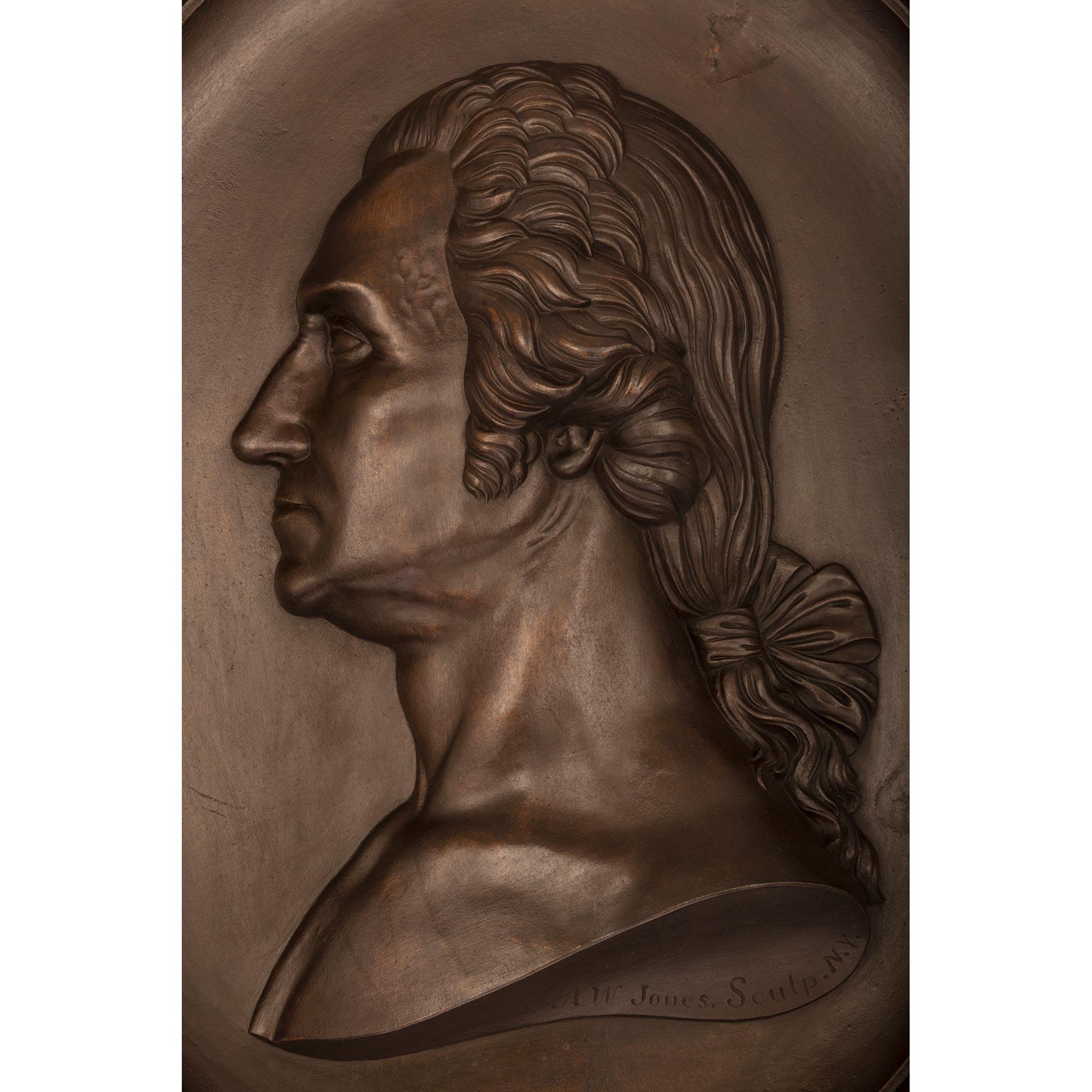 A beautiful and very high quality American 19th century Louis XVI st. patinated bronze plaque of George Washington by Anthony W. Jones circa 1858. The plaque displays an exceptional and most decorative oak branch with fine acorns and an olive branch