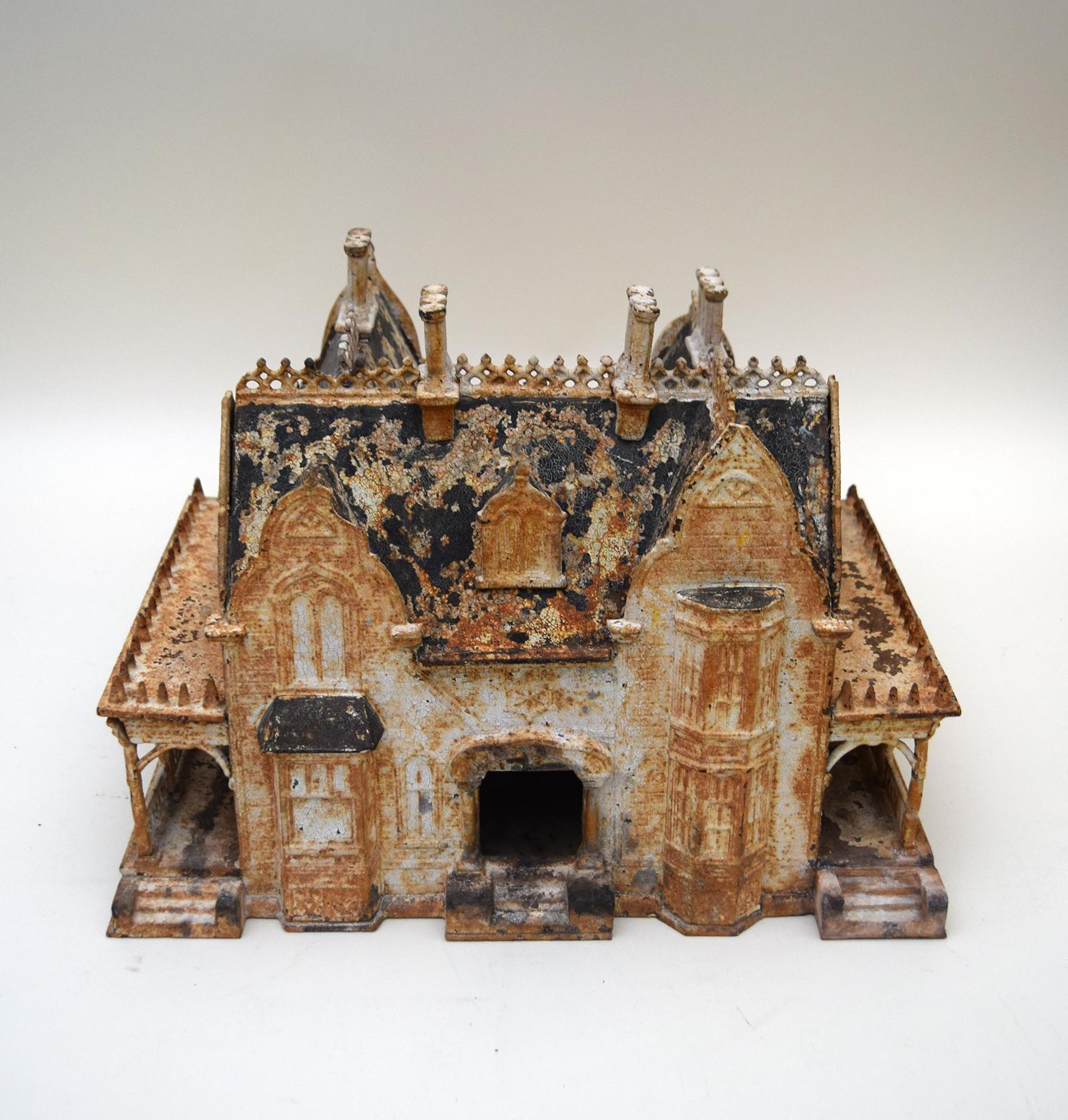 This charming 19th century Victorian birdhouse was modeled on the Neo-Gothic mansions that were then being built for the potential buyers of birdhouses. Cast in iron, it bears the name of its Rhode Island maker, the Miller Iron Company, and dated