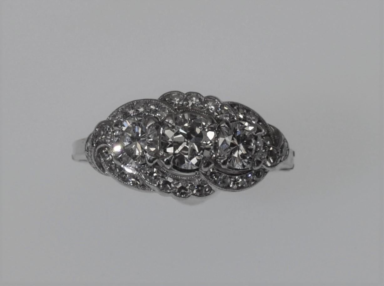 Diamonds lead the look with this beautiful American Classic Antique Style Diamond Ring.  This gorgeous antique ring has over two carats of faceted round diamonds with the center stone .60 ct , the two sides .43 ct each and the additional accent