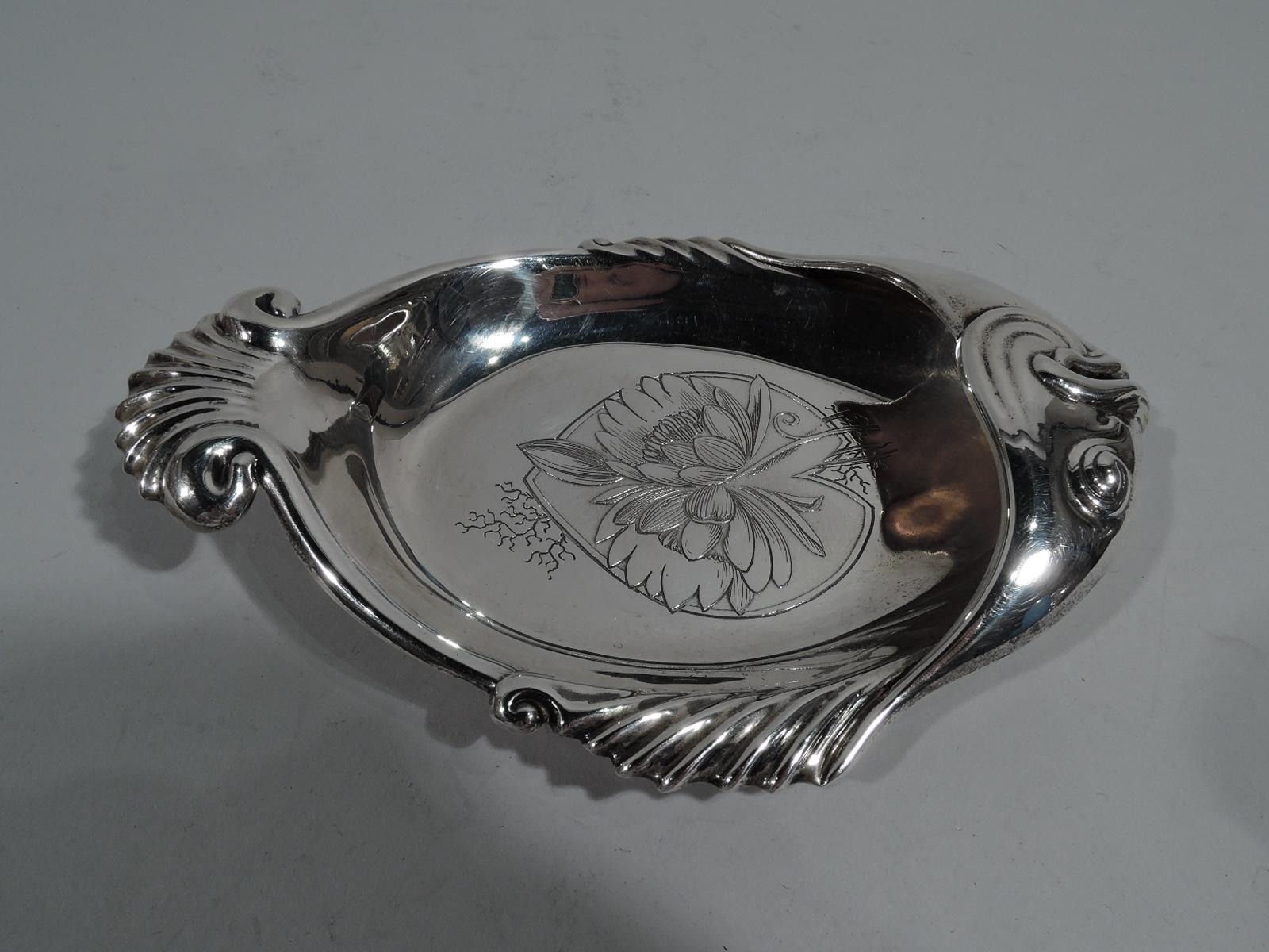 Aesthetic sterling silver fish dish. Made by Whiting in New York, circa 1885. Curved sides, gadrooned fins and tail, and head with chased jowls, lips, and eyes. Stylized flowers engraved in well. Modish Japonesque design. Fully marked including no.