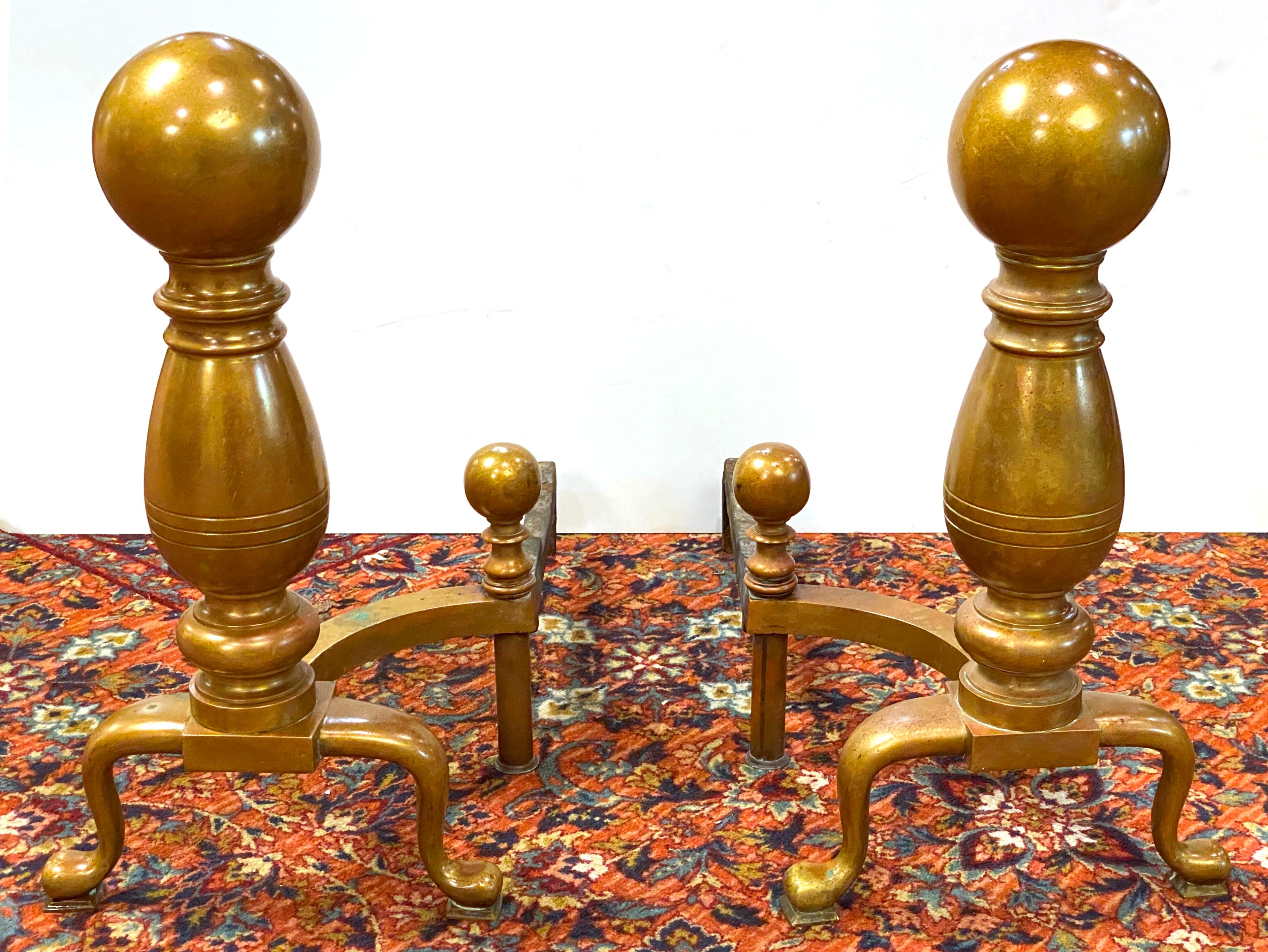 American Aesthetic Movement pair of monumental size polished brass andirons, made during the 1880s in the United States. The pair is in great antique condition with age-appropriate wear and use.