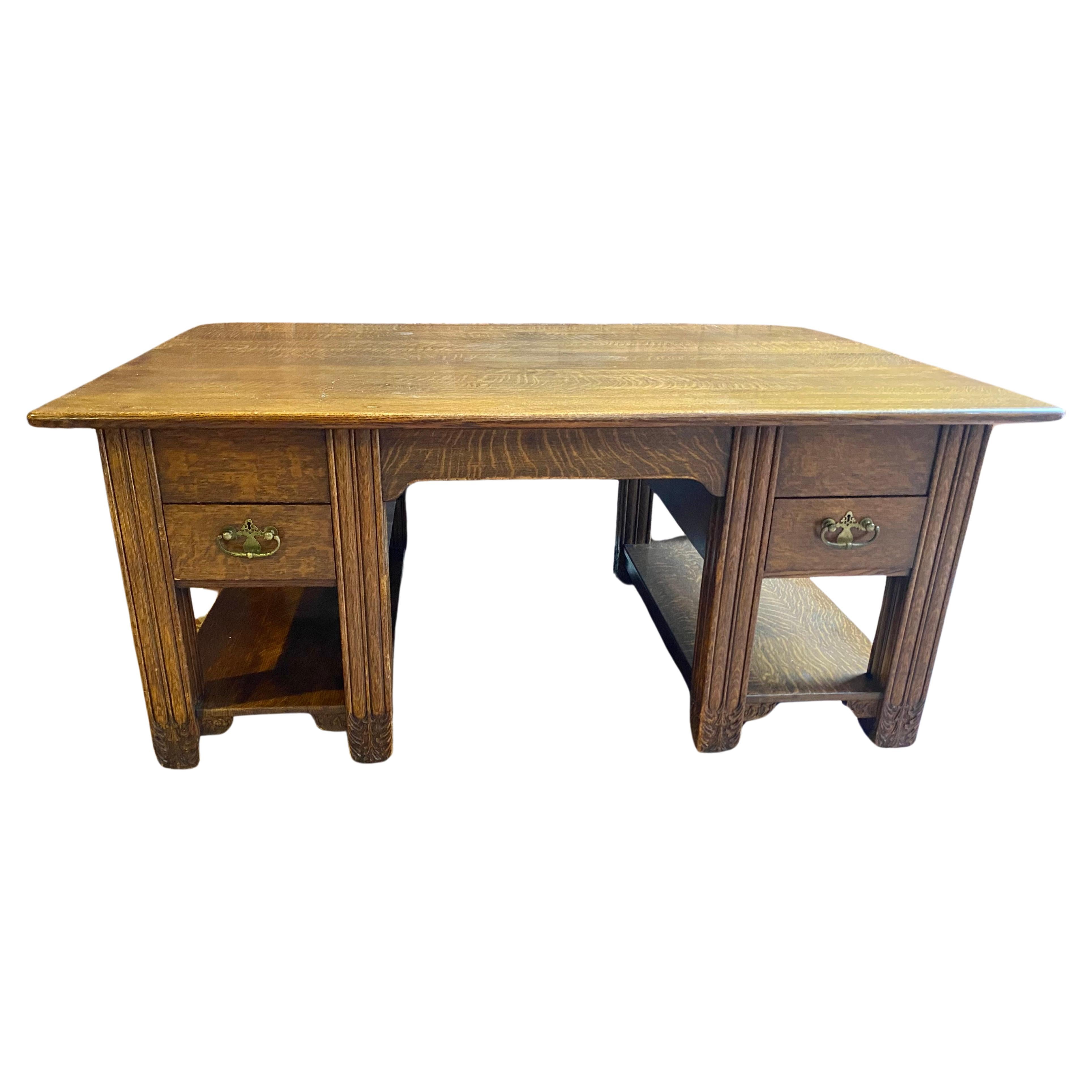 American Aesthetic Oak Partners Desk manner Louis Comfort Tiffany.. Large and handsome antique oak partner's desk, Gorgeous grain, brass hardware.carving to the massive feet.Drawers and workspace on both ends as well as storage where each person