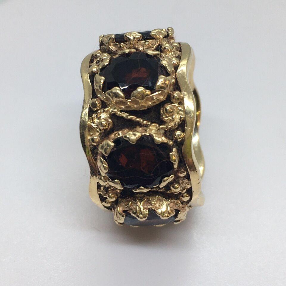 American Antique Art Deco 14k Gold Garnet Eternity Band 30s

Finger size: 6.5
Width: 13mm/ 1/4 inch
Weight: 11.6 gram
Country of origin: United States
Gems: 7 pieces of Garnet appx 8 mm by 6 mm Oval Cut
Condition: pre-owned, no scratches on stones,