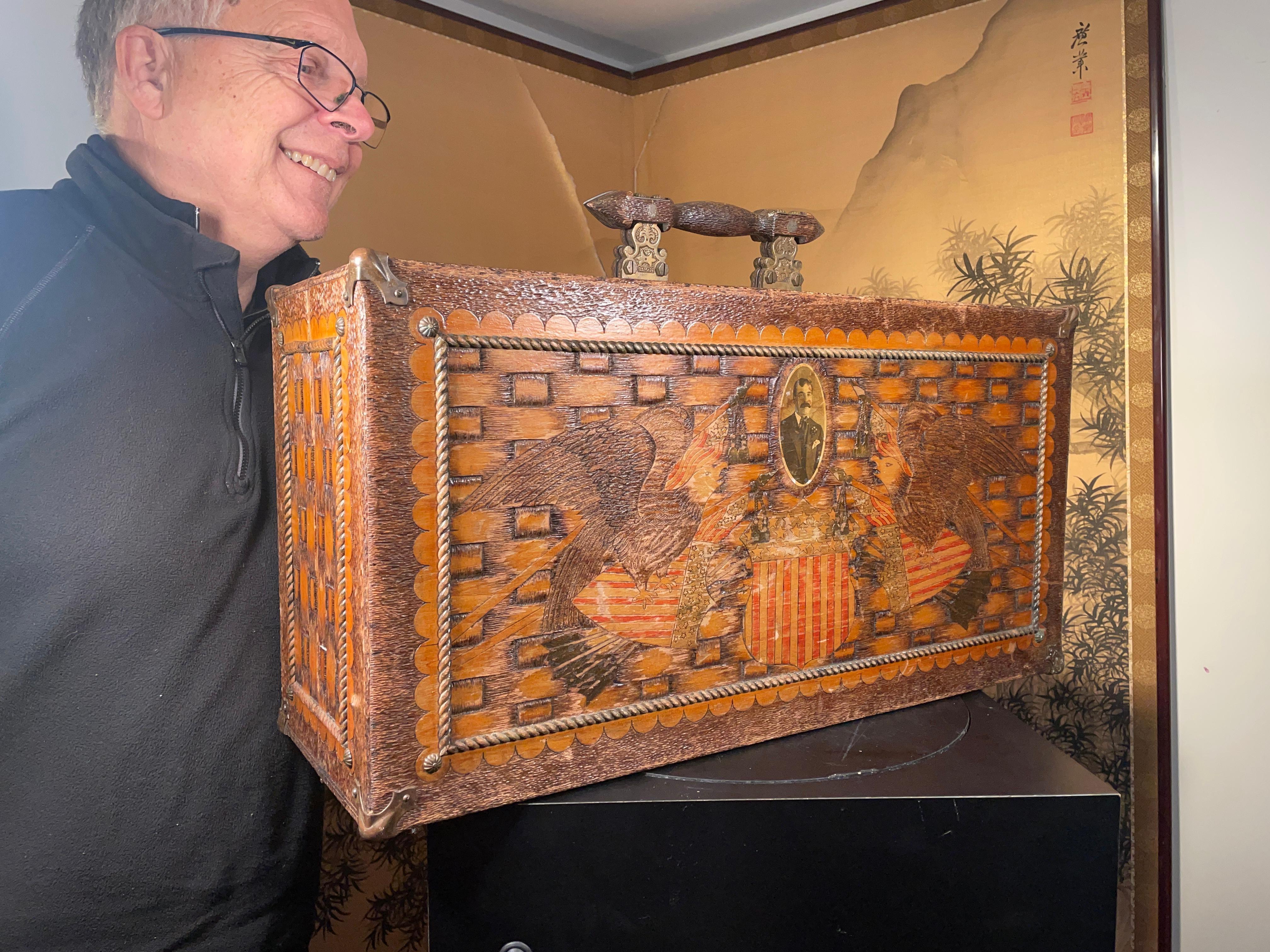 From an old New England collection.

An elaborate antique american folk art pyrography wood trunk. This highly detailed suitcase is hand crafted of wood and brass - the wood has been burned, carved & painted with American heraldic symbols