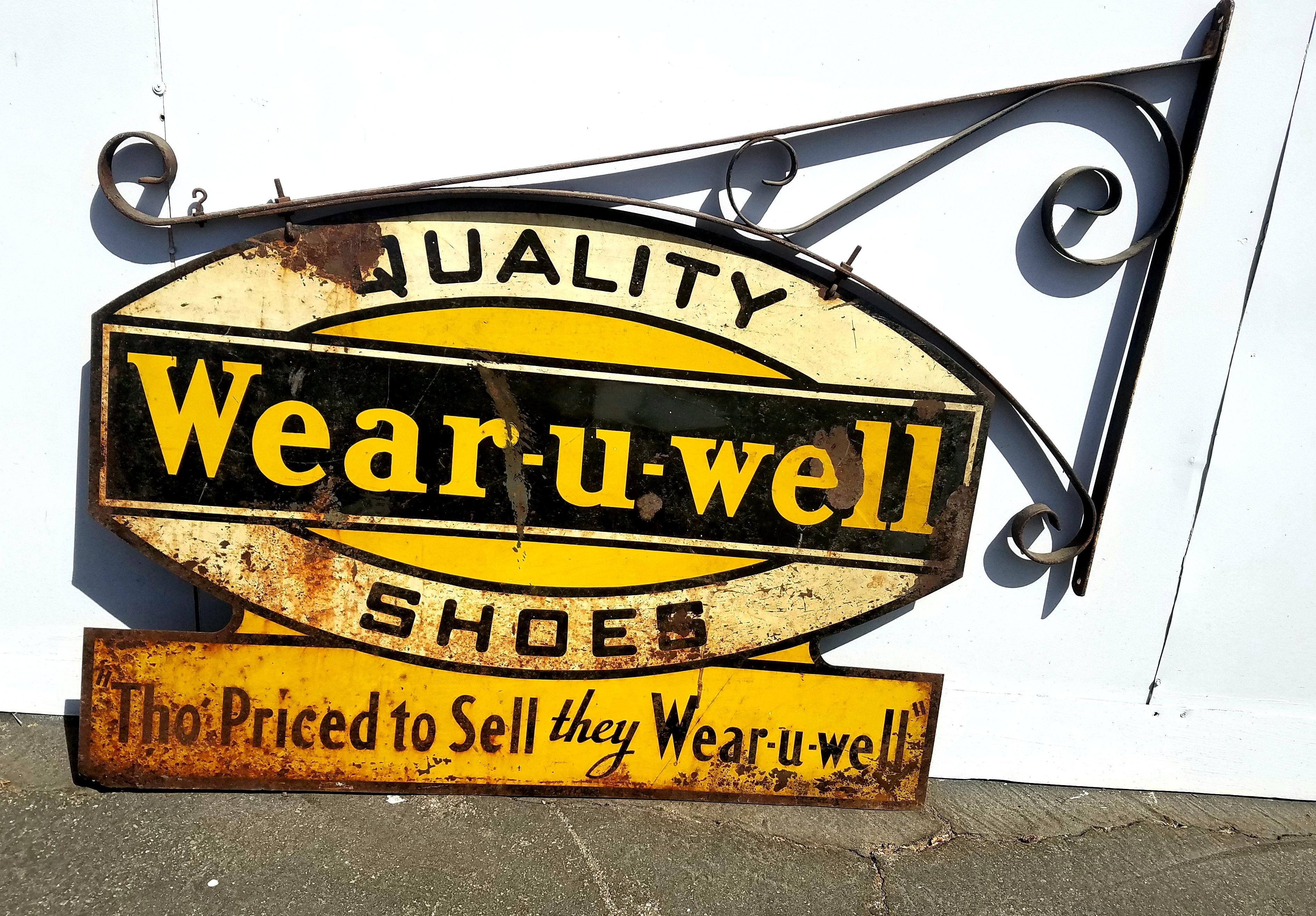 Antique American sign for the shoe store. Double sided ,wrought iron base and hand painted bout sides all in original condition .
