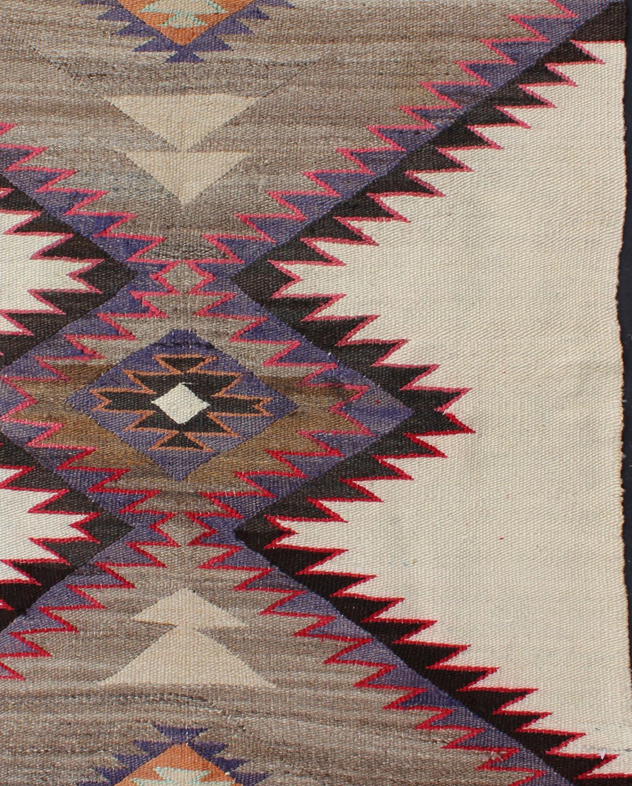 This intriguing antique Navajo rug, (circa 1930) was woven in the United States during the first half of the 20th century. The exciting and unique composition boasts a captivating geometric composition with an all-over diamond latch hooked design.