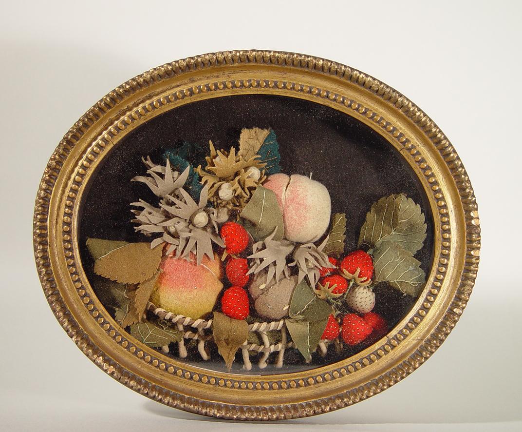 American oval shadow box felt picture depicts strawberries in an openwork straw basket with the large long handle rising above. Within an oval gilt frame. 

Great strong color.

.