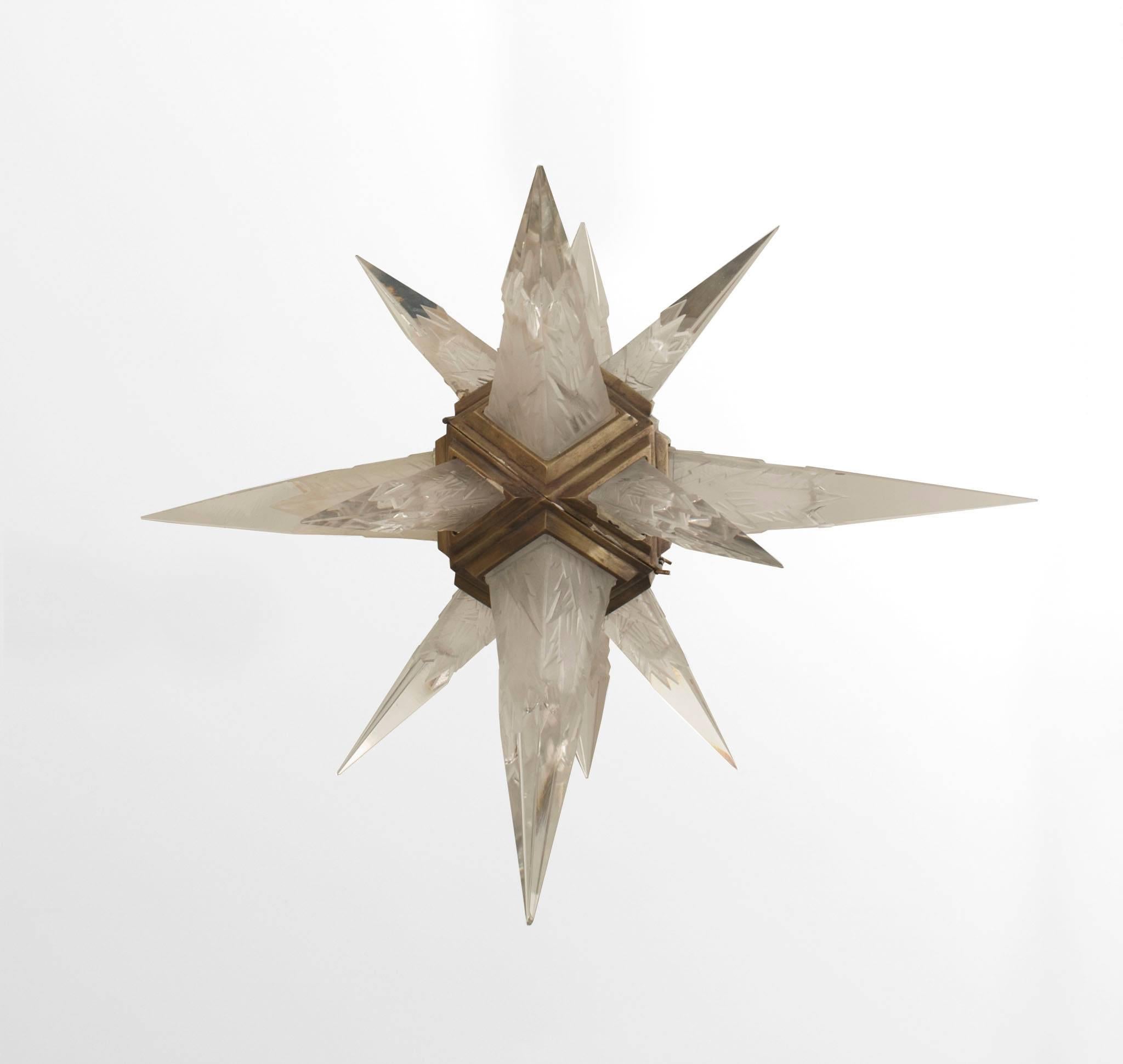 American Art Deco star form chandelier with clear & frosted glass spikes having a geometric design emanating from a silvered bronze cage (by C.J. WEINSTEIN), 1930s.

        