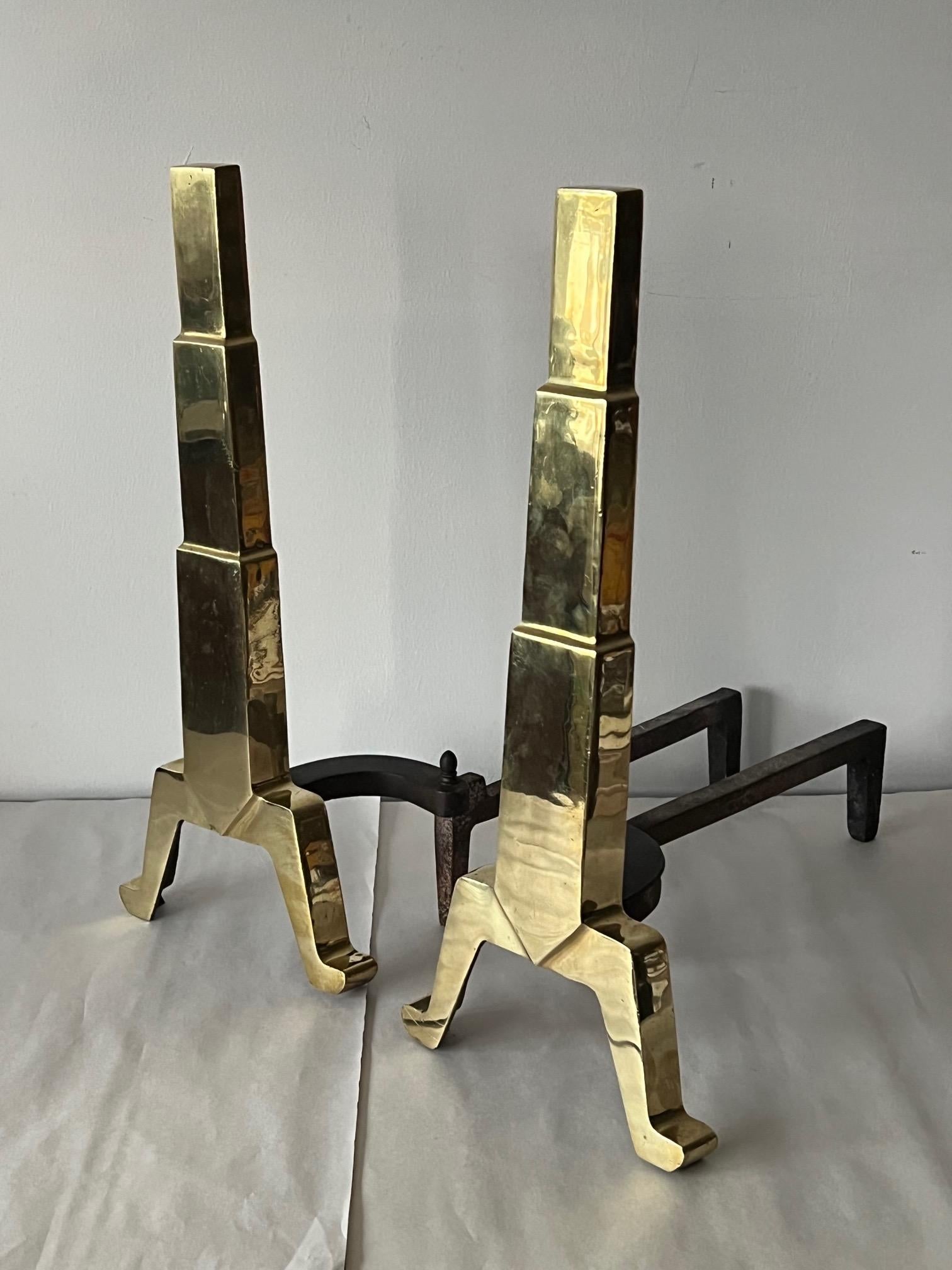 A pair of unusual andirons-Art Deco stylized skyscraper look. Polished brass, heavy and well made.