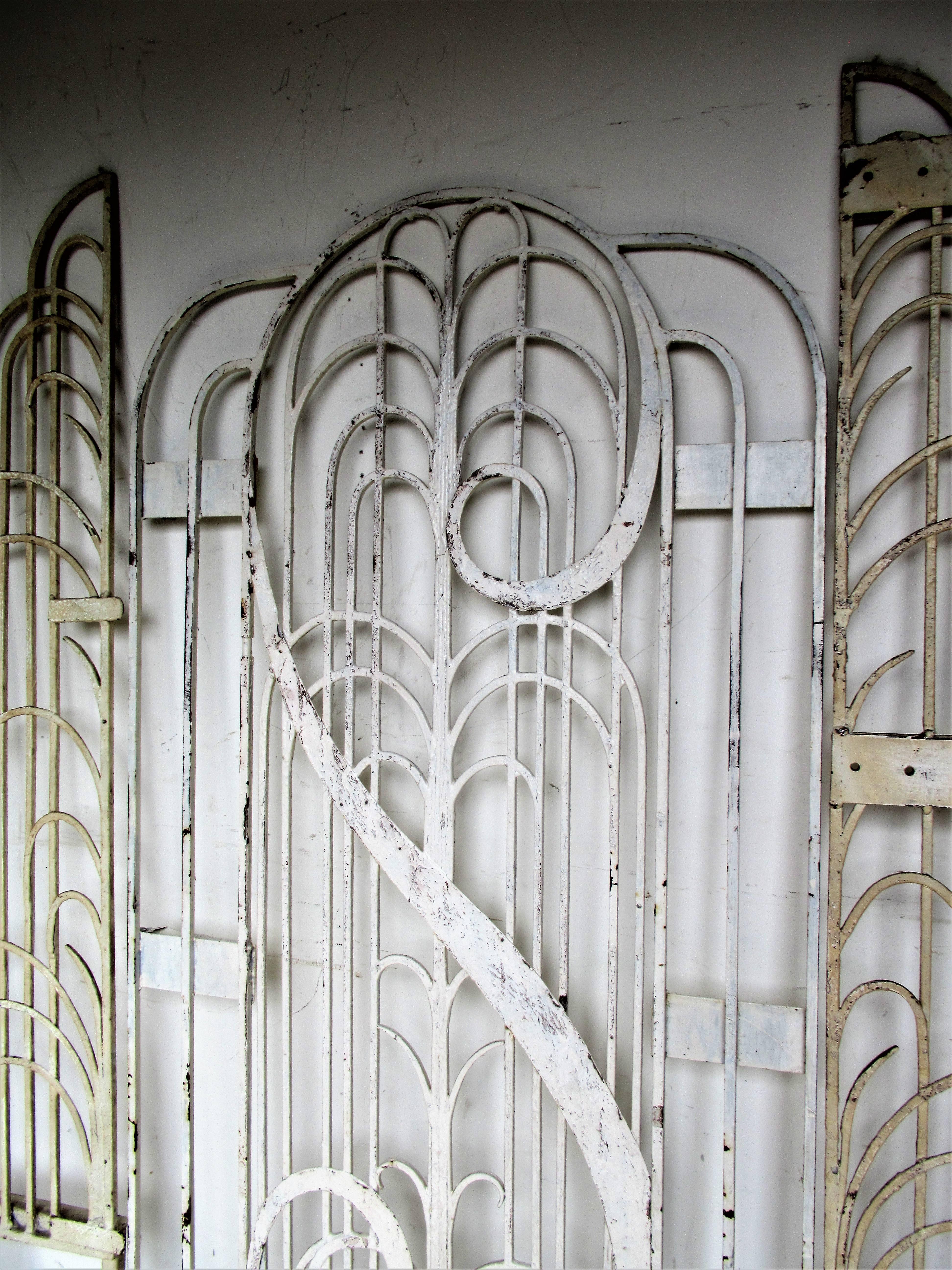 1930s American Art Deco iron gates / large centre section and two side sections in old white and cream painted surface. Hand-wrought by Perrine Bros. Ornamental Iron Co. Topeka, Kansas.
