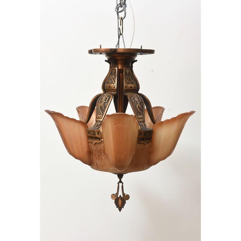 American Art Deco fixture by Markel Corporation. A central glass bowl surrounded by 5 glass slip shades, flush mounted for lower ceilings and high traffic areas. All original amber colored glass. Cast bronze frame with restored. Original bronzed