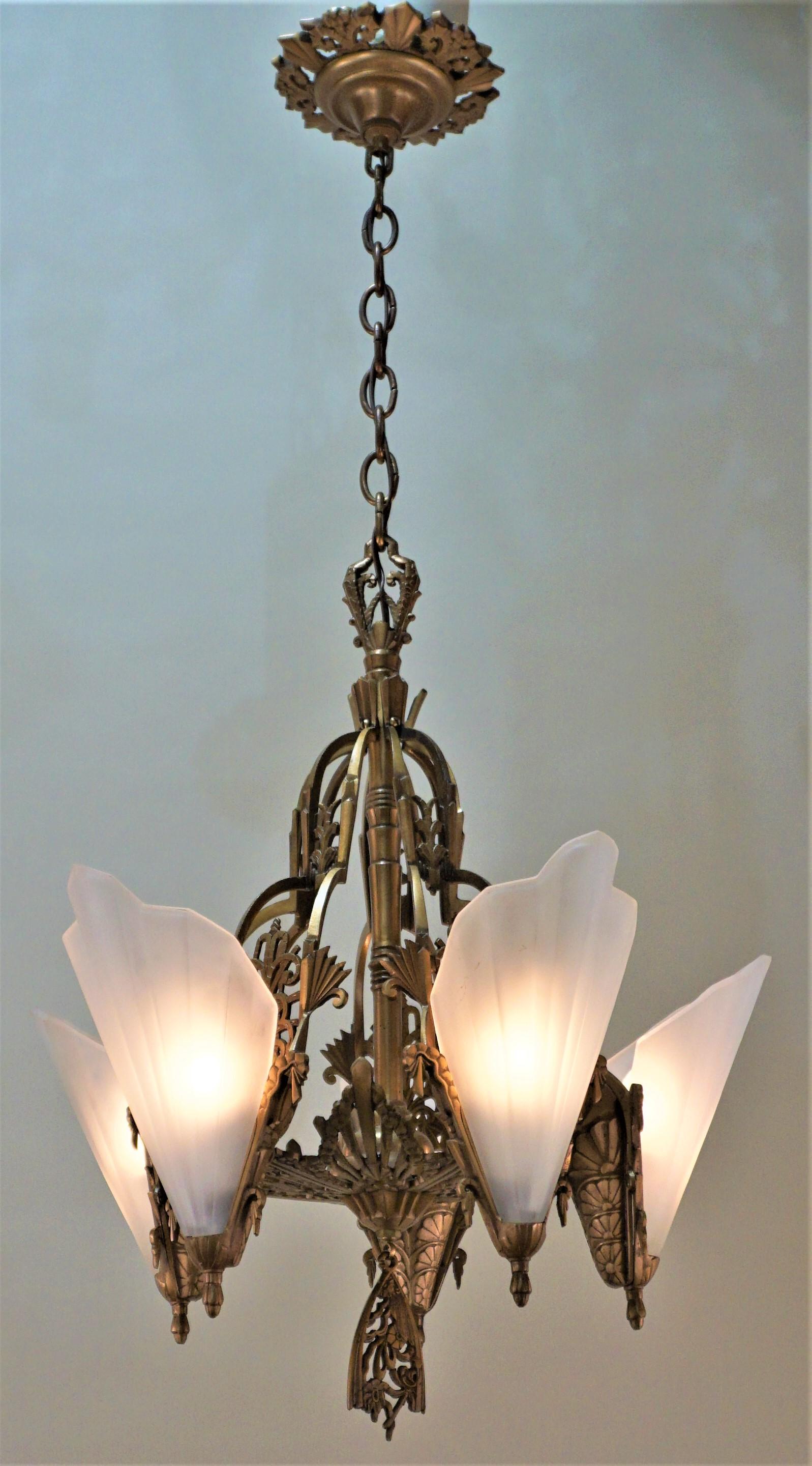 One of the best design of American Art Deco chandeliers, clear frost glass with bronze frame.
Measures: 21