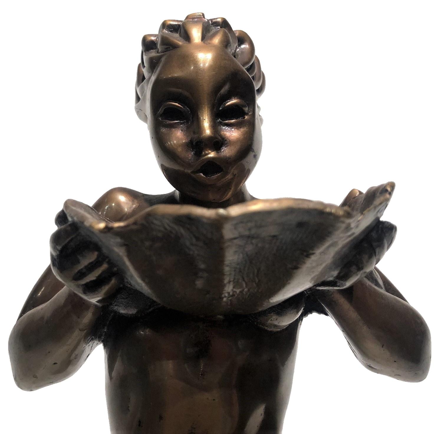 ABOUT
A light, graceful female figure, as if floating in the air, with hair fluttering in the wind, trying not to spill, carefully carries in front of her a large sea shell filled with water. Probably, this most unusual bronze sculpture was part of