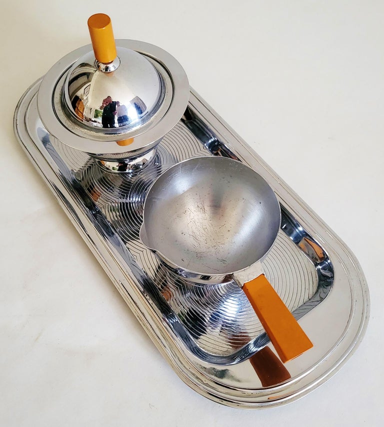 This American Art Deco chrome and amber Bakelite 3-piece set made its first appearance in the Chase catalogue of 1936 as the 