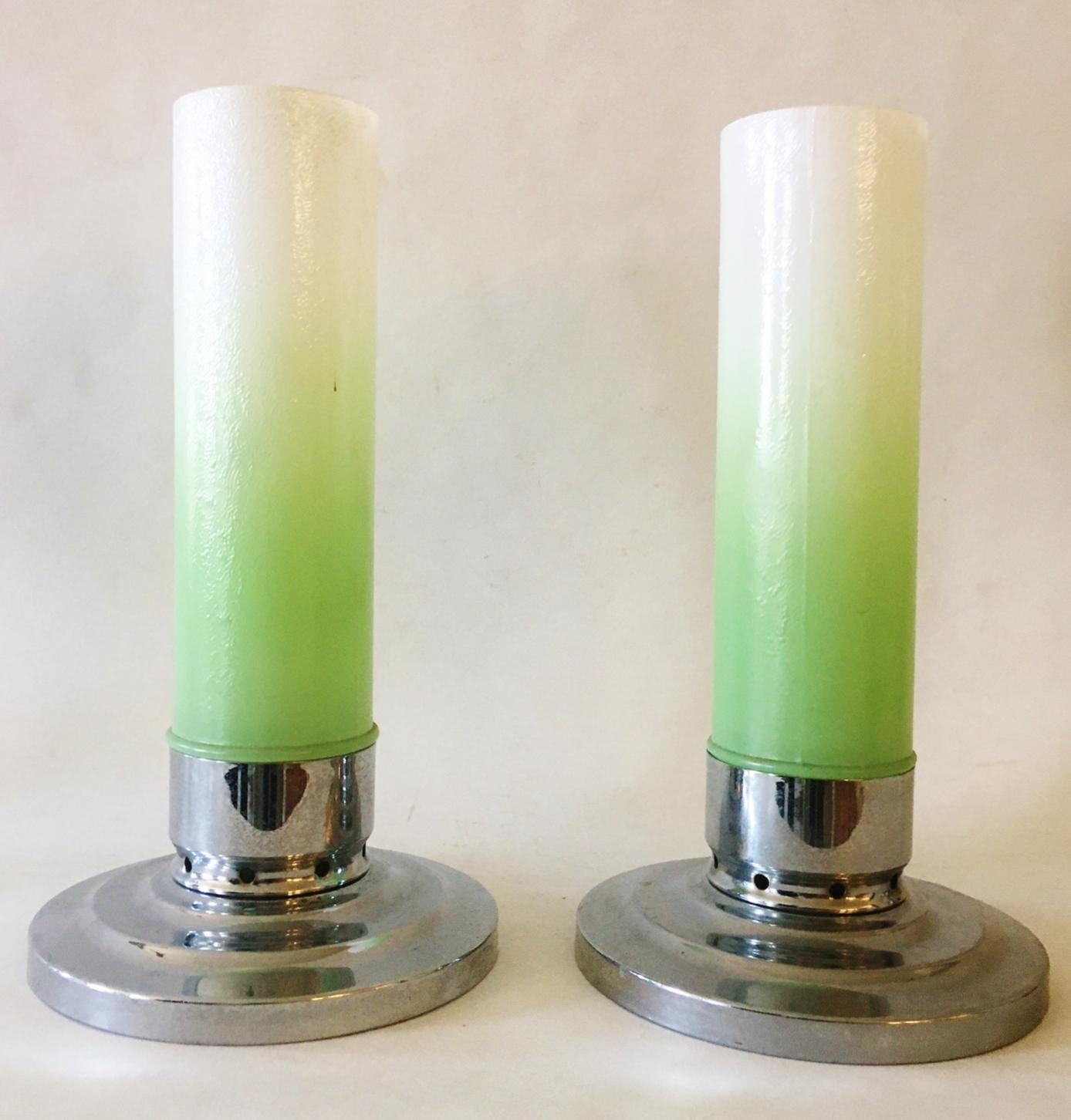 This pair of American Art Deco chrome and glass shaded candle holders were produced by F.T, Haffner Company of Chicago. The shades is particular pair are in green and white vignetted glass with a polished chrome stepped disk base. Over the years we