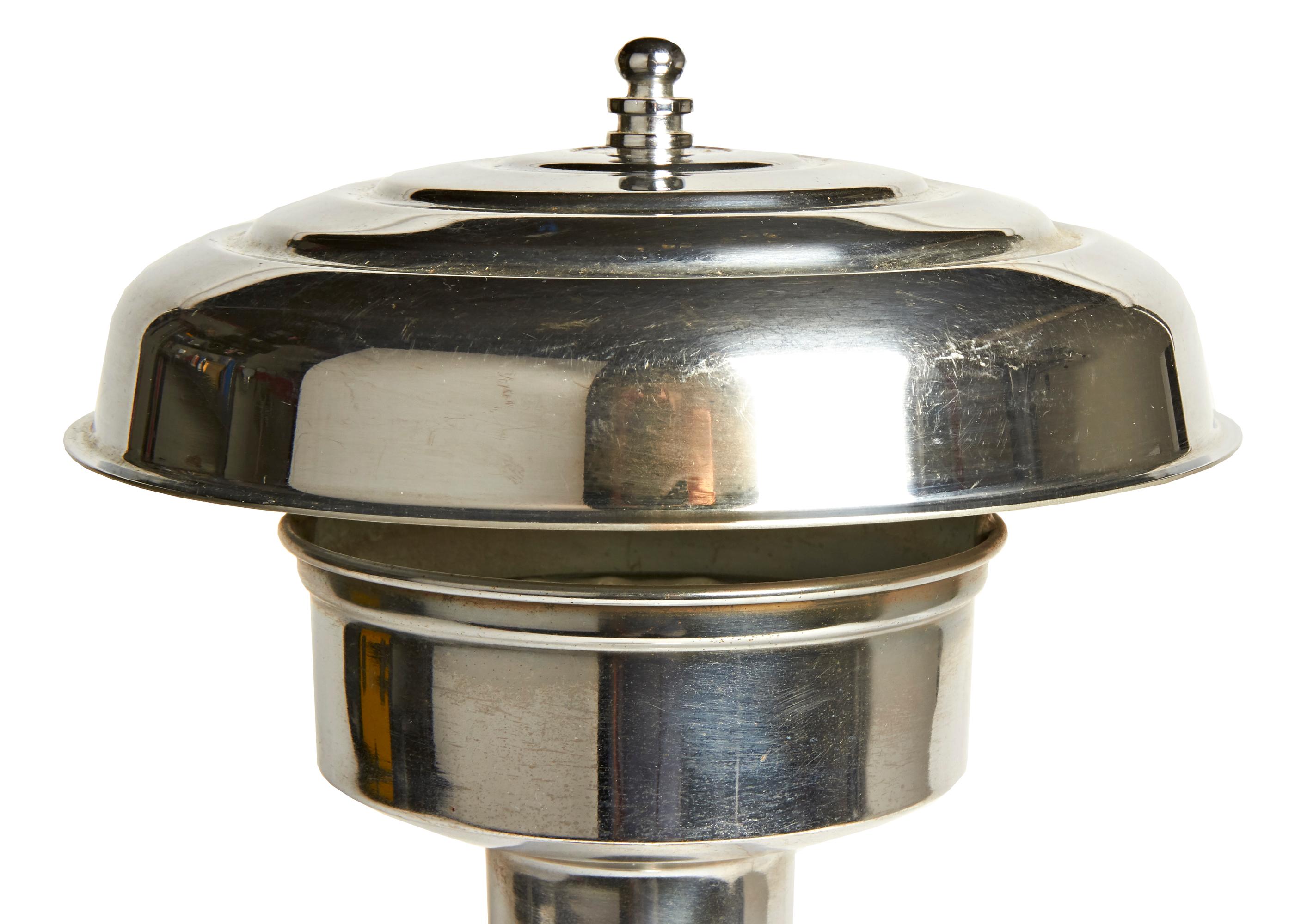 This tall and elegant American Art Deco chrome-plated table lamp features a weighted stepped base with its original brown baize covering. A fluted column rises up from the base and is topped by a two level, chrome gallery that holds its original