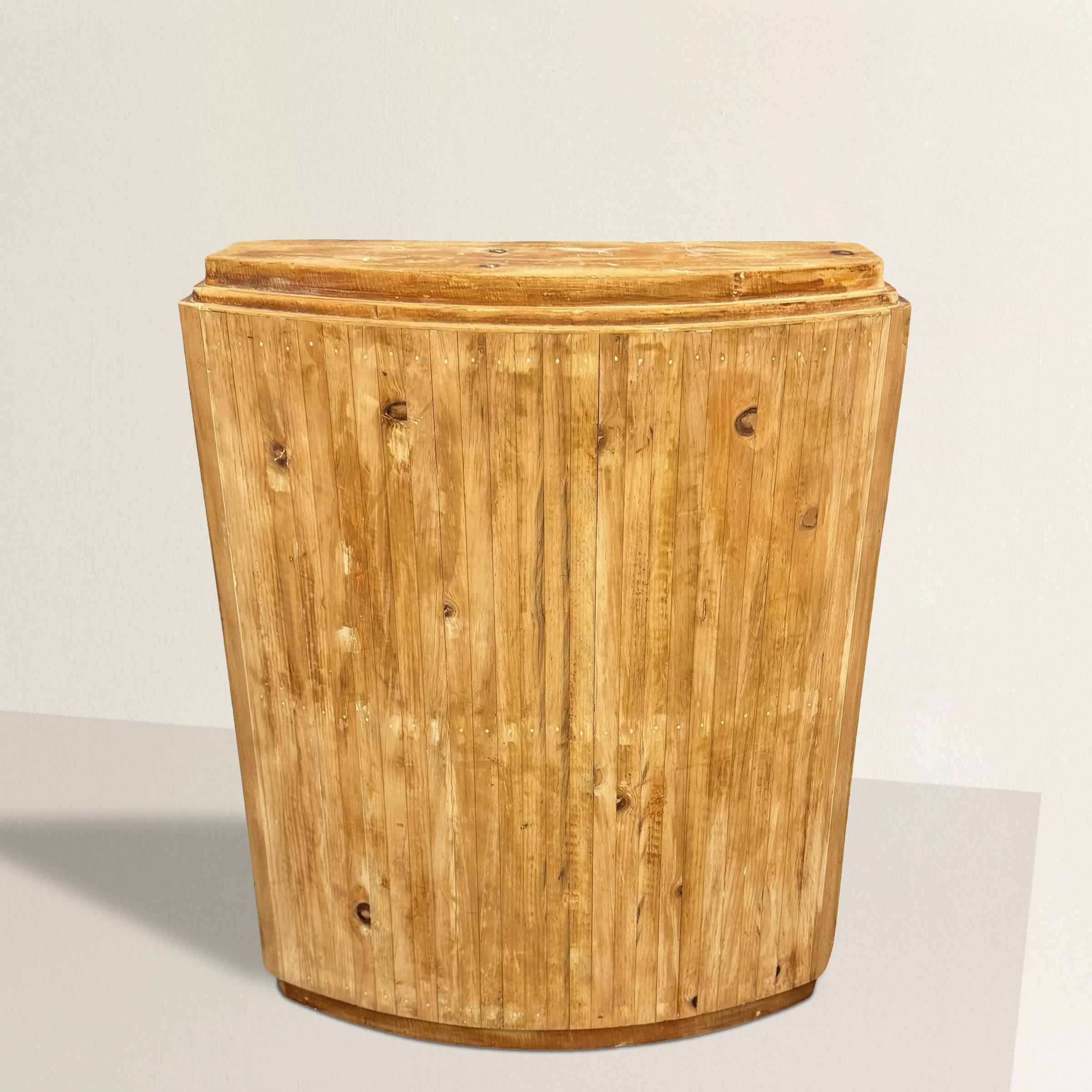 This American Art Deco console table offers a striking balance between the elegance of its era and the warmth of raw, natural wood. With a slightly bowed front, rounded corners, and a classic three-stepped top, it embodies the streamlined