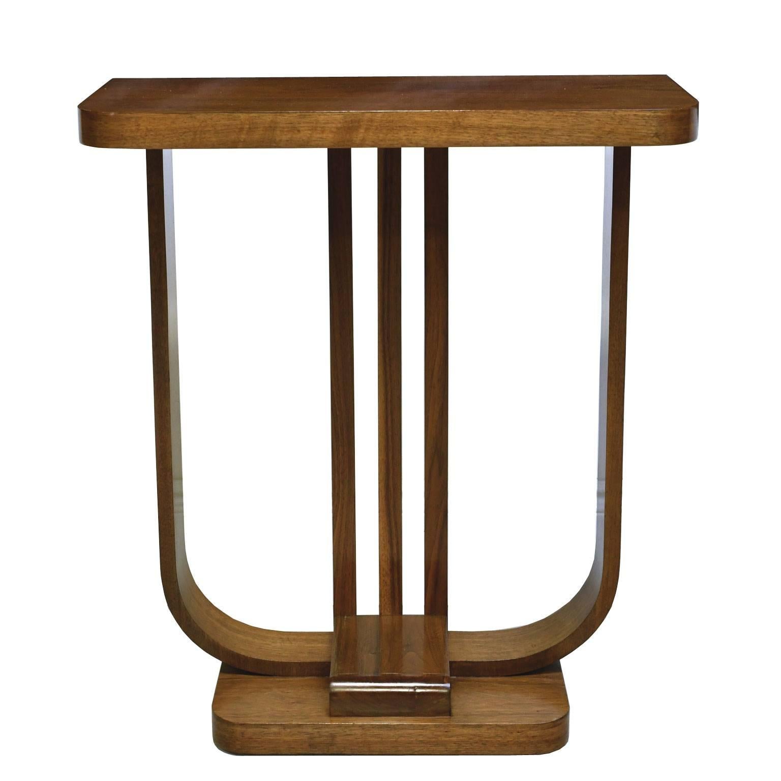 A very handsome Art Deco console table in the form of a streamlined lyre, with narrow rectangular top resting on 