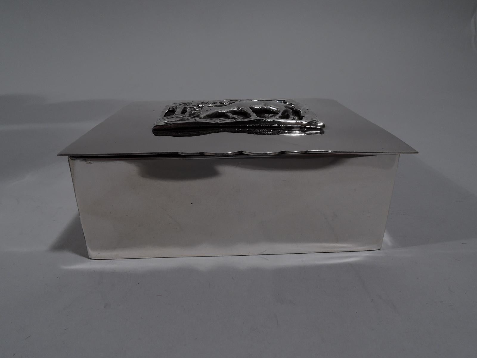 American Art Deco craftsman handmade sterling silver box, circa 1920. Rectangular with straight sides. Cover flat and hinged with slight overhand and cutout tab. Applied to cover is open rectangle with popular period motif of herbage-nibbling