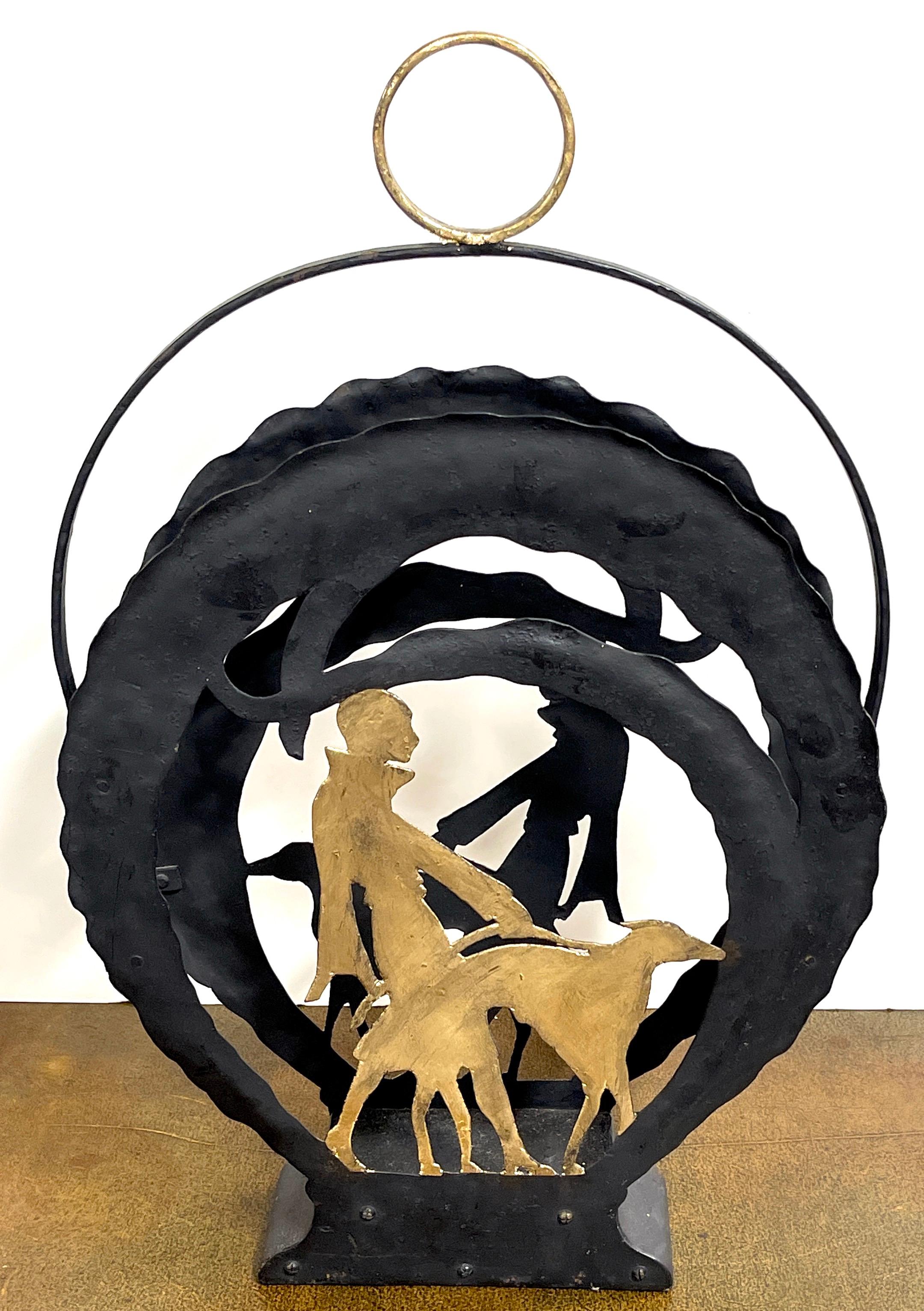 American Art Deco gilt iron flapper walking dog Vignette Magazine Rack 
USA, Circa 1930s

A beautifully pierced wrought iron with circular gilt handled dual sided vignette of a gilt silhouette of a stylish flapper walking a leashed large dog