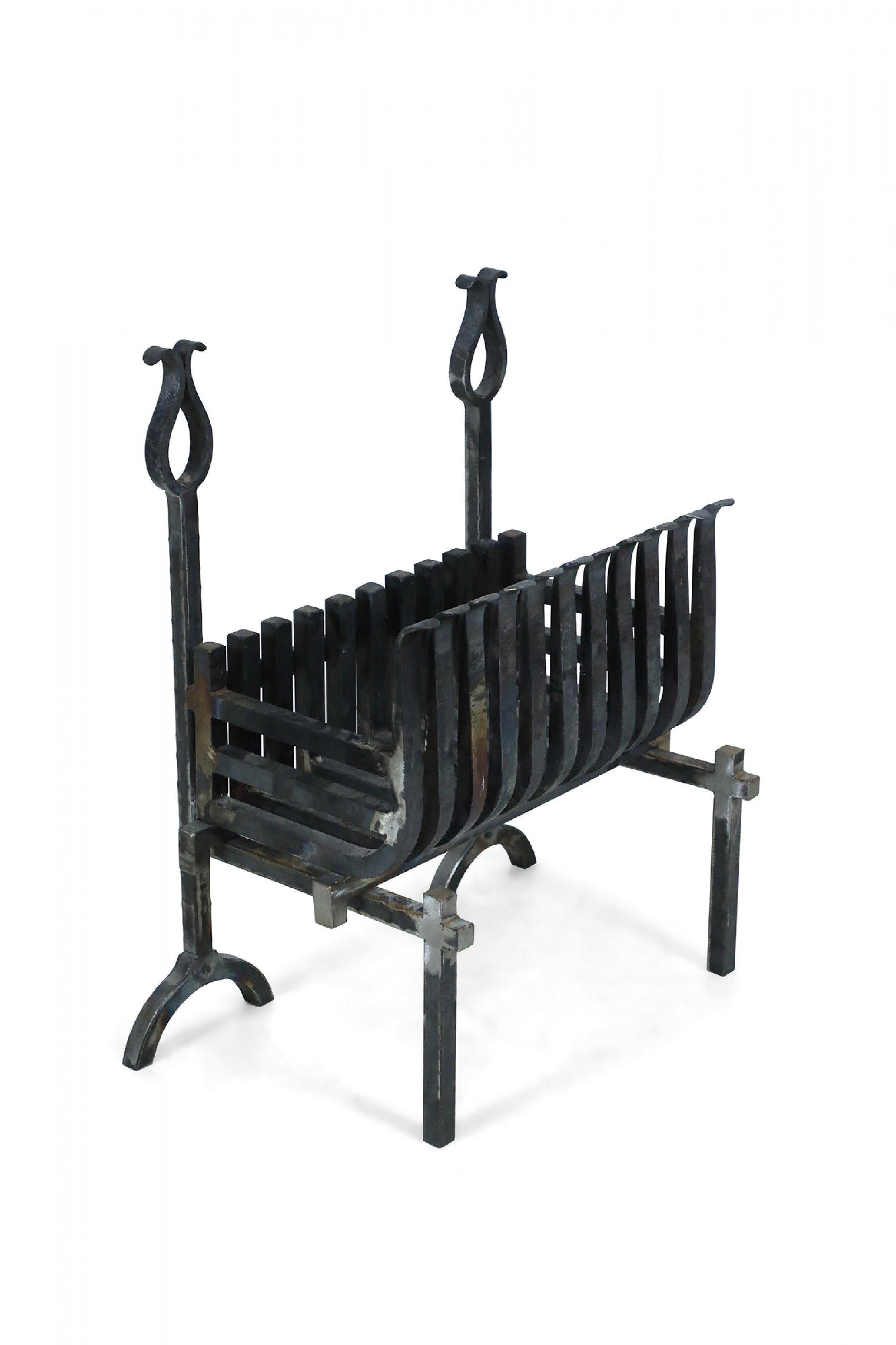 American Art Deco 3-piece iron fire grate comprised of a curved iron slat grate resting on two independent andirons.
 