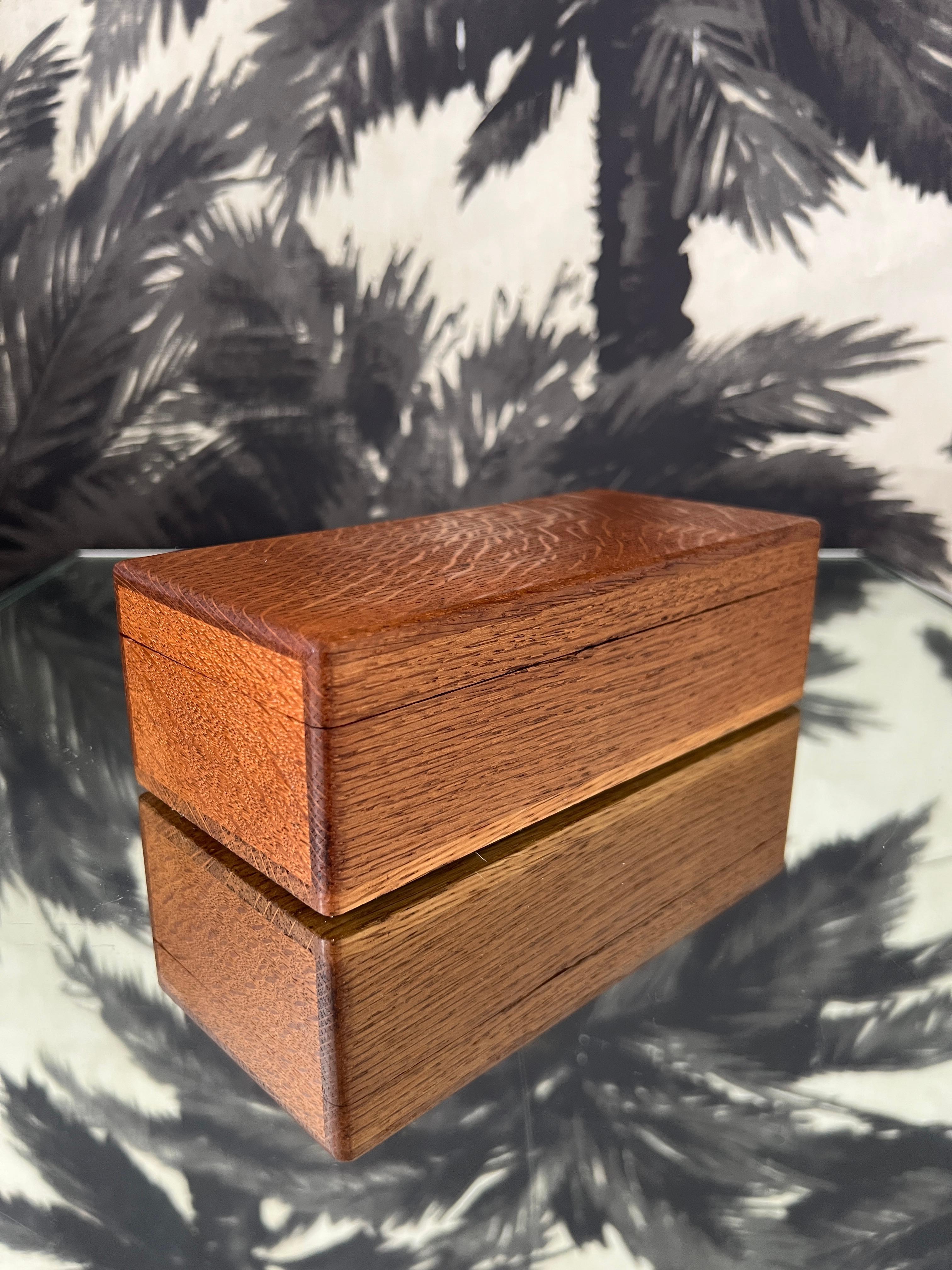 Handcrafted Art Deco era keepsake box in tiger oak wood. The box has a streamline design featuring two wood colorations and is fitted with double interior compartments for jewelry or trinket storage. Makes a handsome desk or dresser accessory.