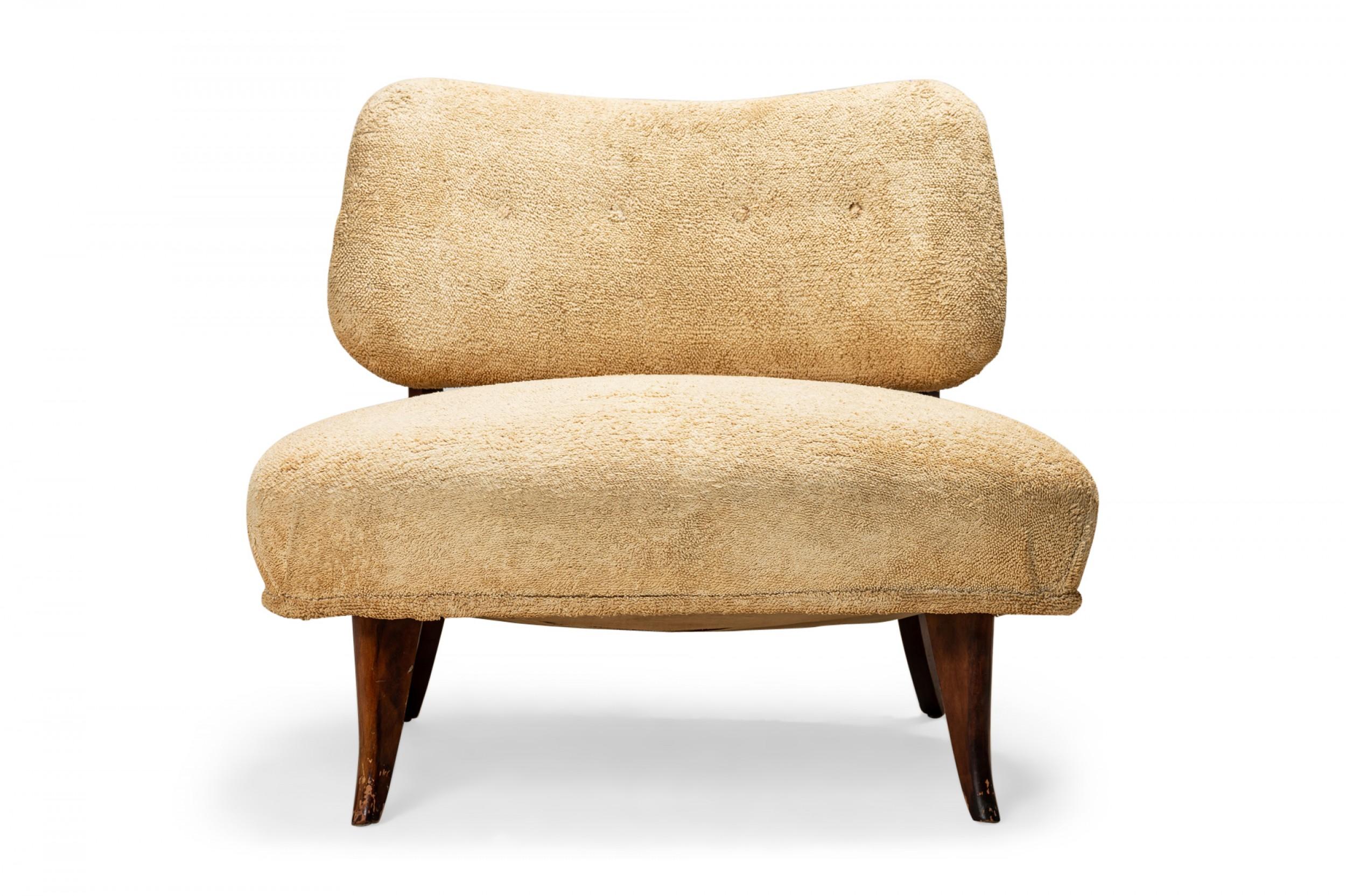 American Art Deco low slipper / side chair with beige terrycloth upholstery, resting on four short walnut legs. (manner of T.H. ROBSJOHN-GIBBINGS)
