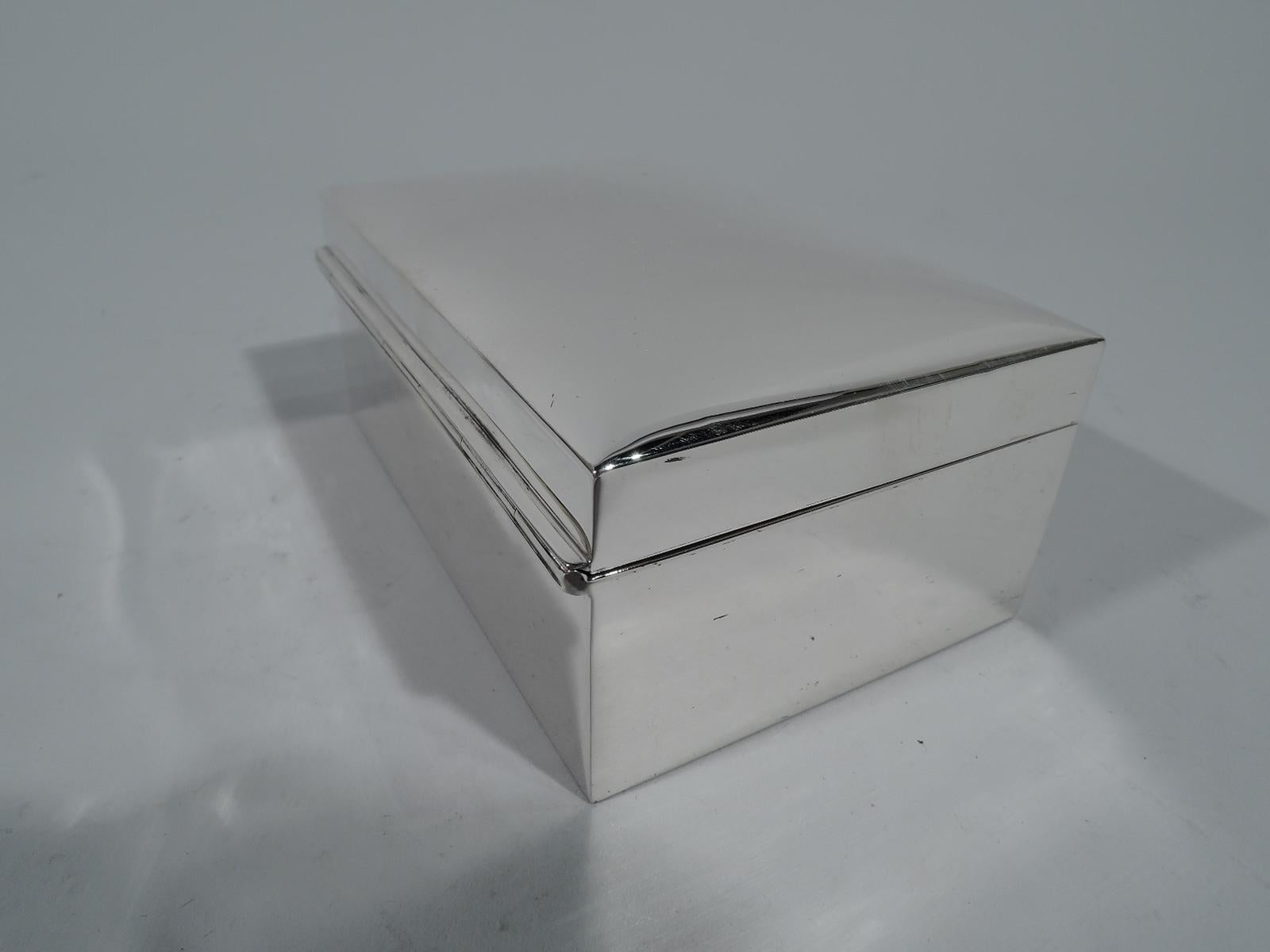 Modern sterling silver jewelry box. Rectangular with straight sides. Cover hinged and curved with tab. Box and cover interior velvet lined. Hallmarked by John Chatellier, a New York maker active, circa 1915-1930s. Numbered 160. Gross weight: 7.6