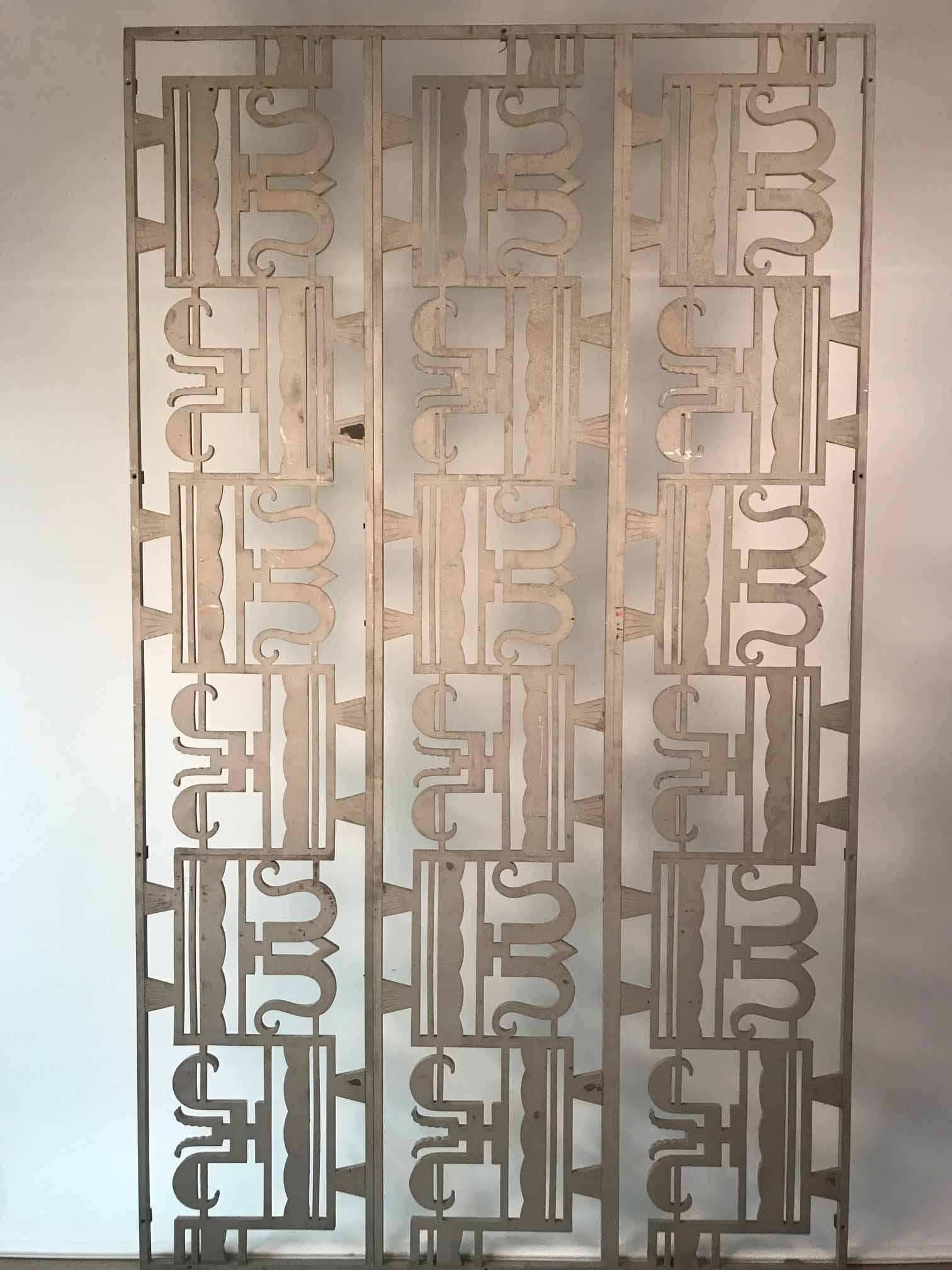 This was acquired in New York City, we believe it to be American and custom made for a wealthy client. The panels are cast with a stylised curving motif in an alternating pattern. This is an architectural element from the period and could now be