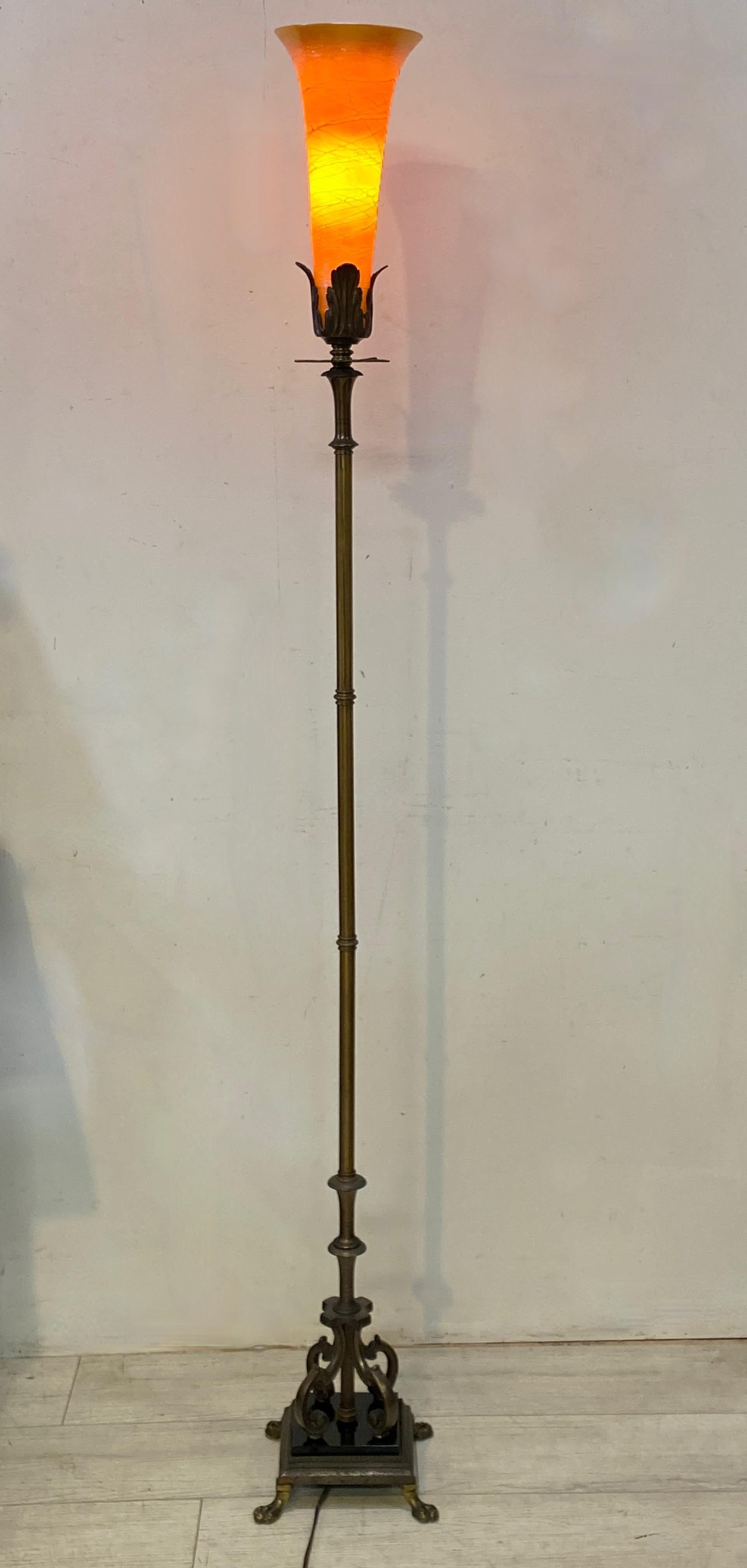 An elegant 1920s brass, cast iron and jet black glass floor lamp stand (base) with period cased iridescent Durand art glass shade. 
American, early 20th century.
Some very minor indications of wear on the base, the shade is in excellent original