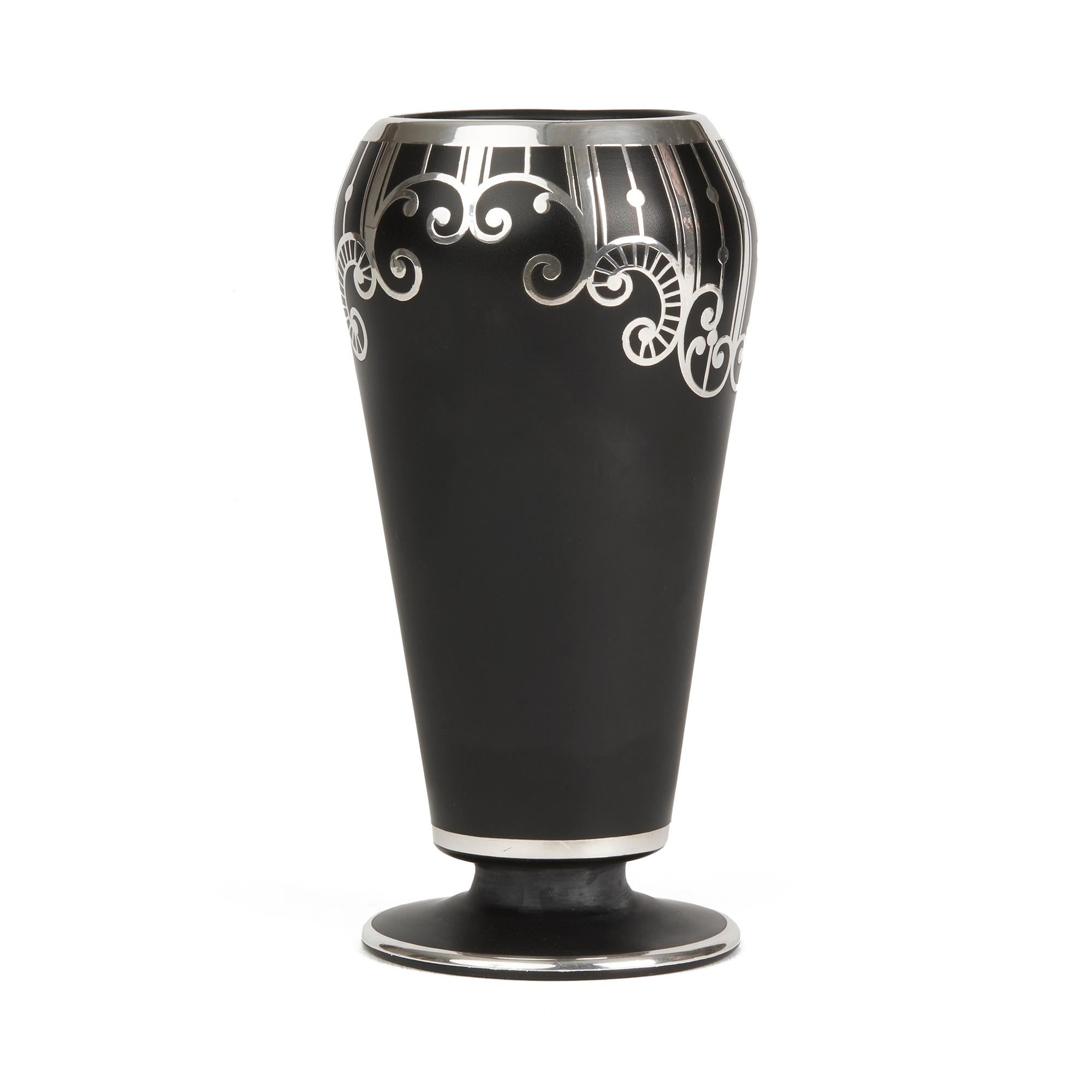 A fine American Art Deco black glass vase with silver overlay by the Rockwell Silver Company. The tall bulbous shaped vase stands on a wide rounded flat base and has a quality scroll patterned design applied around the upper body with the edges