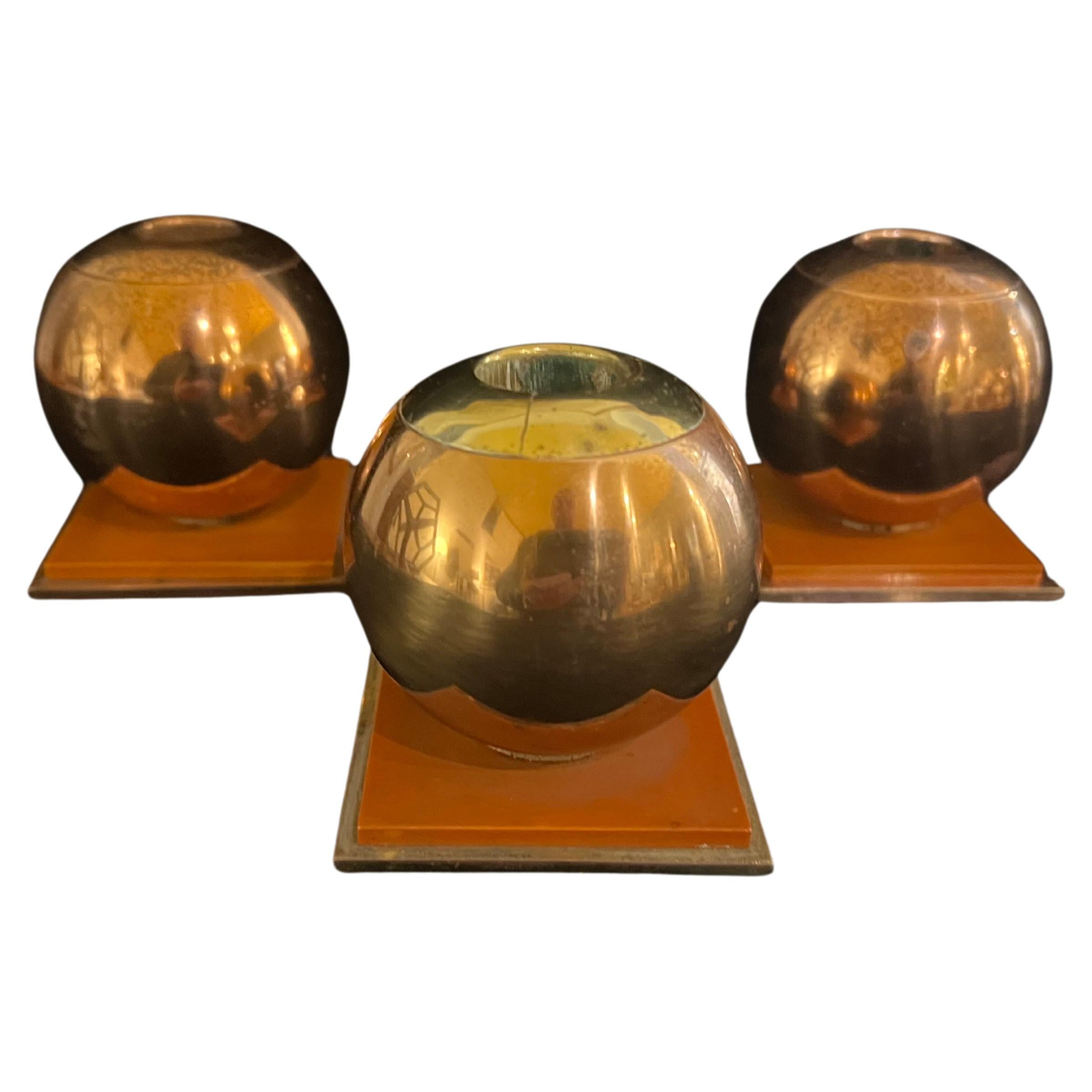 Beautiful and rare set of 3 art Deco candle holders designed by Russel Wright , for Chase circa 1940s in copper and bakelite one with a brass top .