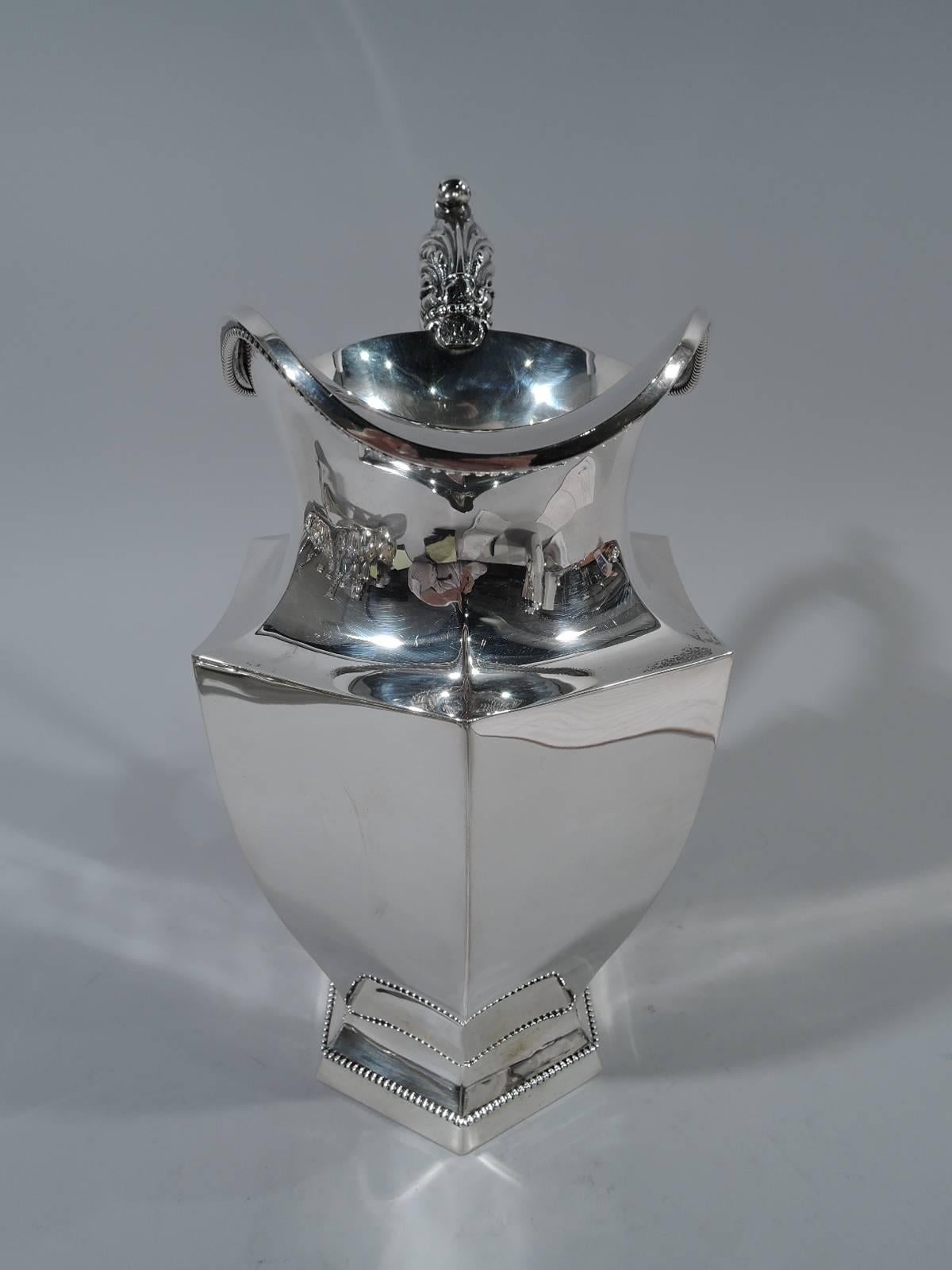 Art Deco sterling silver water pitcher. Made by R. Wallace & Sons in in Wallingford, Conn., circa 1910. Faceted and tapering body with faceted foot. Mouth, foot, and handle rims have applied beading. Handle has leaf cap and mount. An unusual mix of