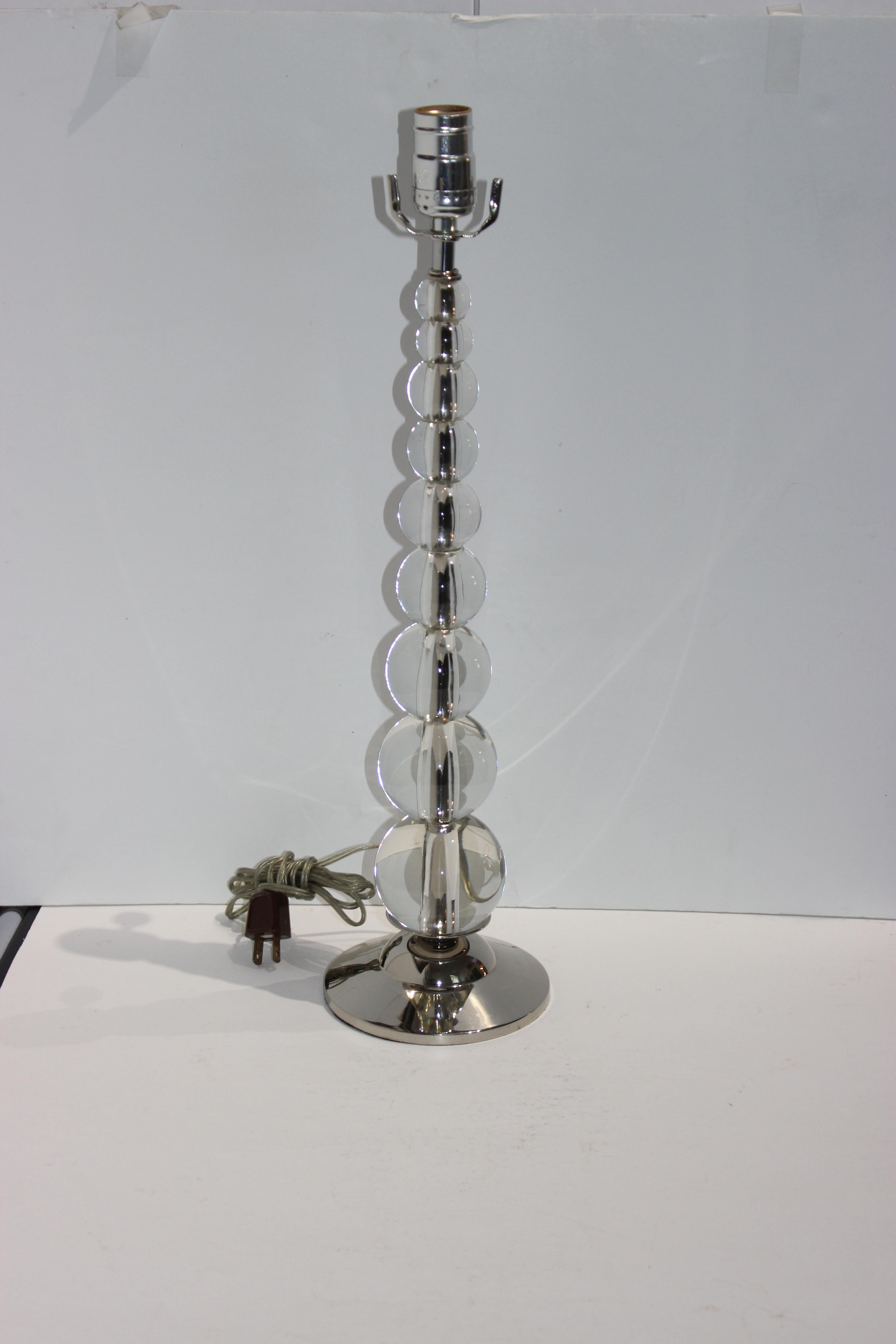 This stylish and chic American Art Deco table lamp was acquired from a Coral Gables estate and it dates to the 1930s. The graduating stacking glass spheres give the piece a lite and clean look.