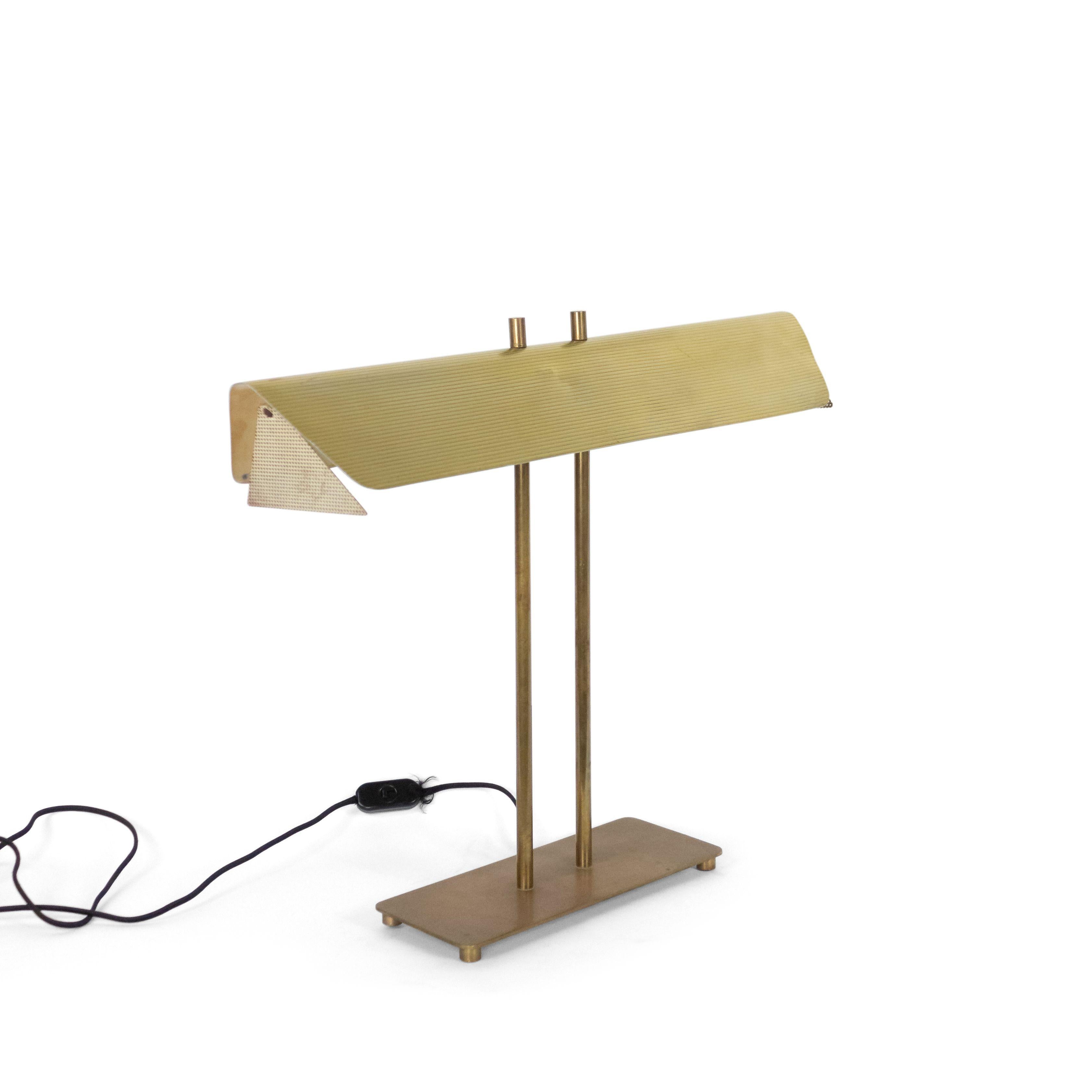 American Art Moderne 1940s brass desk lamp with white perforated sides supported by two columns on rectangular base. (attributed to Paul McCobb).