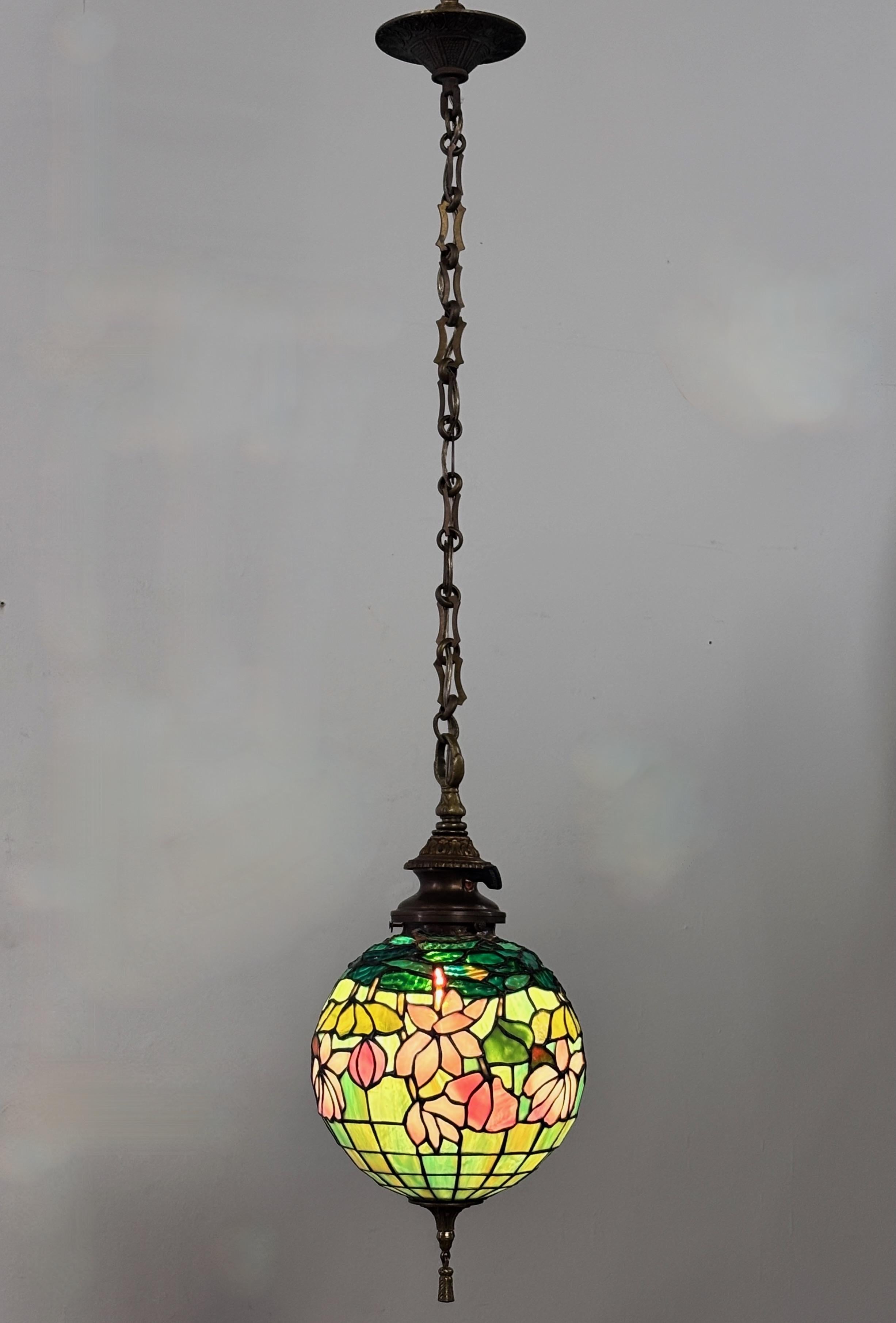 An excellent quality Art Nouveau / Arts & Crafts style orb shaped leaded glass pendent light fixture.
Recently re-wired and ready to install.
This would make an attractive and inviting entryway light or porch light.
Measures 39