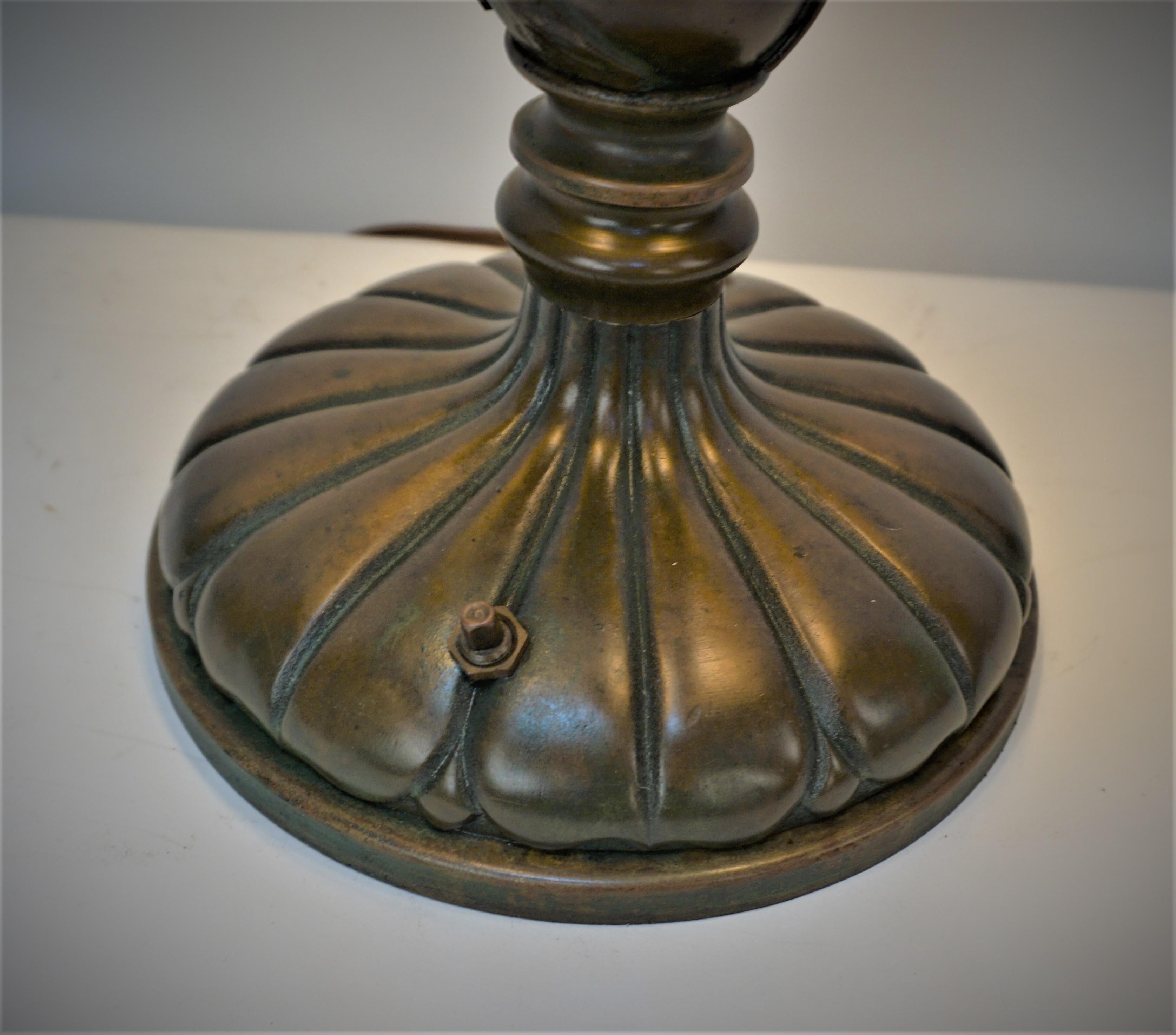 Beautiful brown with touch of green finish bronze art nouveau table lamp with three pull chain sockets and fitted with black lampshade.