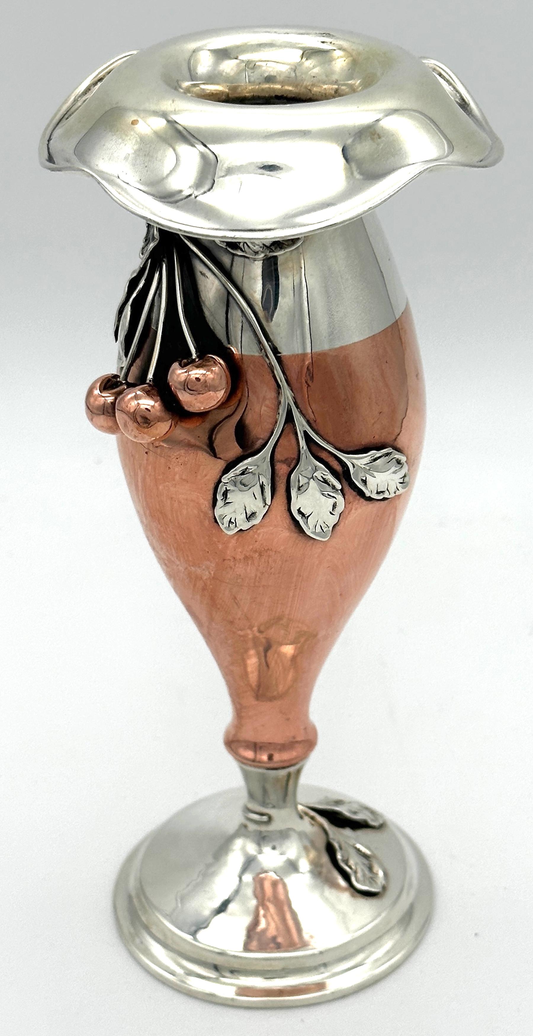 American Art Nouveau Mixed Metal Copper & Sterling Cherry Motif Vase
Unmarked, Attributed to  La Pierre, Newark, N.J., C.1900

Indulge in the  exquisite beauty of American Art Nouveau with this stunning Mixed Metal Copper & Sterling Cherry Motif