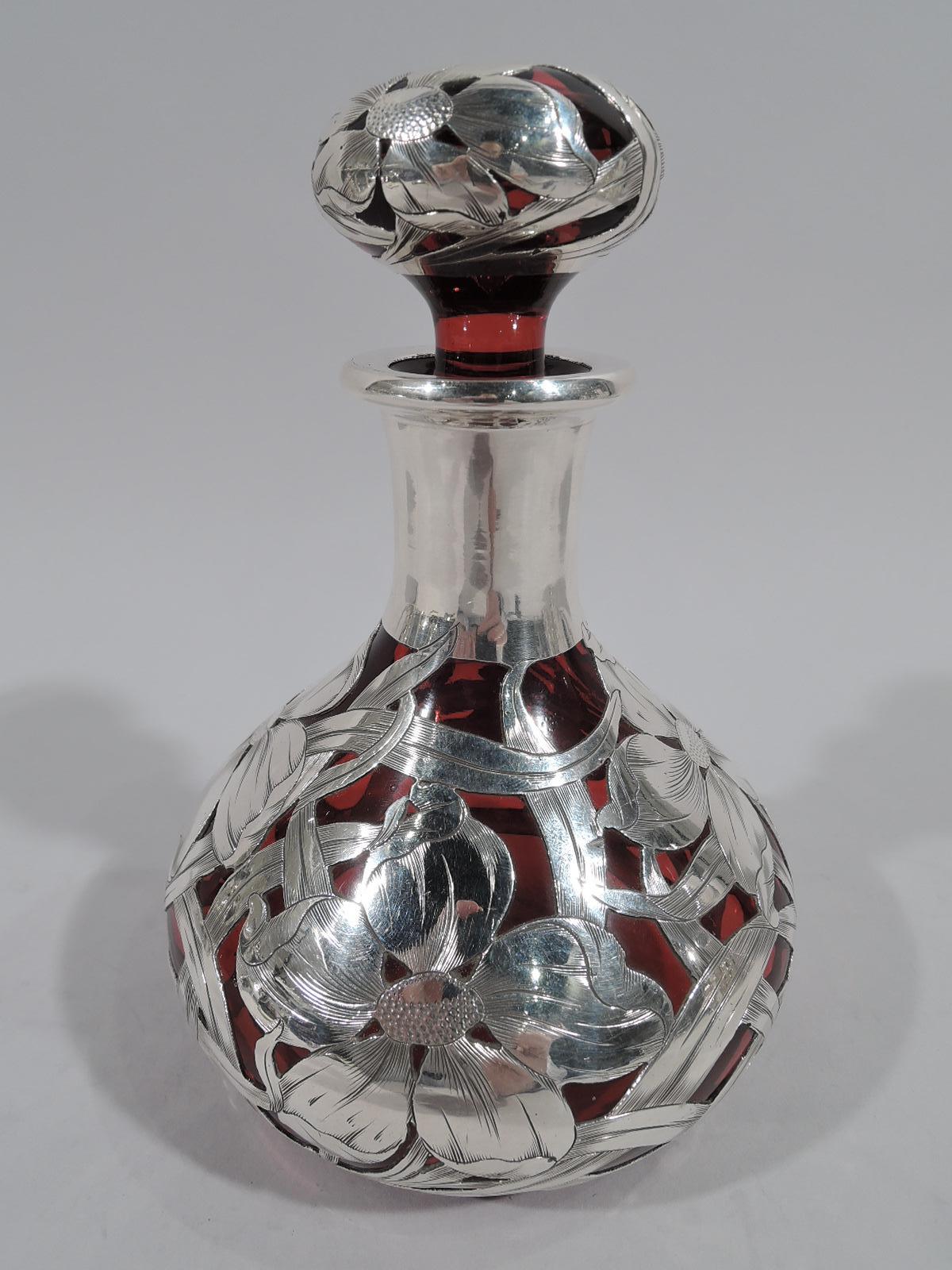 American Art Nouveau red glass perfume with silver overlay, circa 1900. Ovoid with cylindrical neck and flat rim. Stopper flattened ball with short plug. Overlay in form of big bold blooms with interlaced and whiplash tendrils. Dense and loose