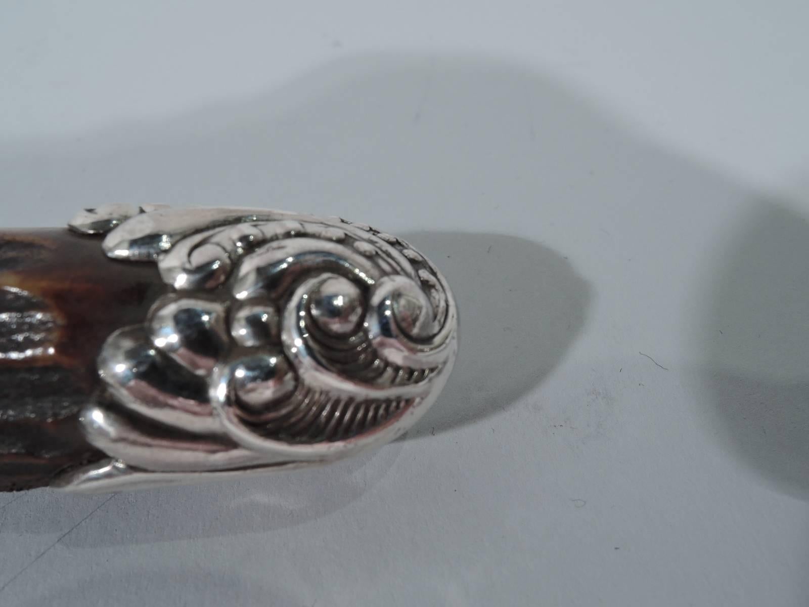 American Art Nouveau sterling silver and horn corkscrew. Horn handle has sterling silver mounts with swirling scrolls, beading, and foliage. Easy grip size and texture. Hallmarked “Sterling”.
