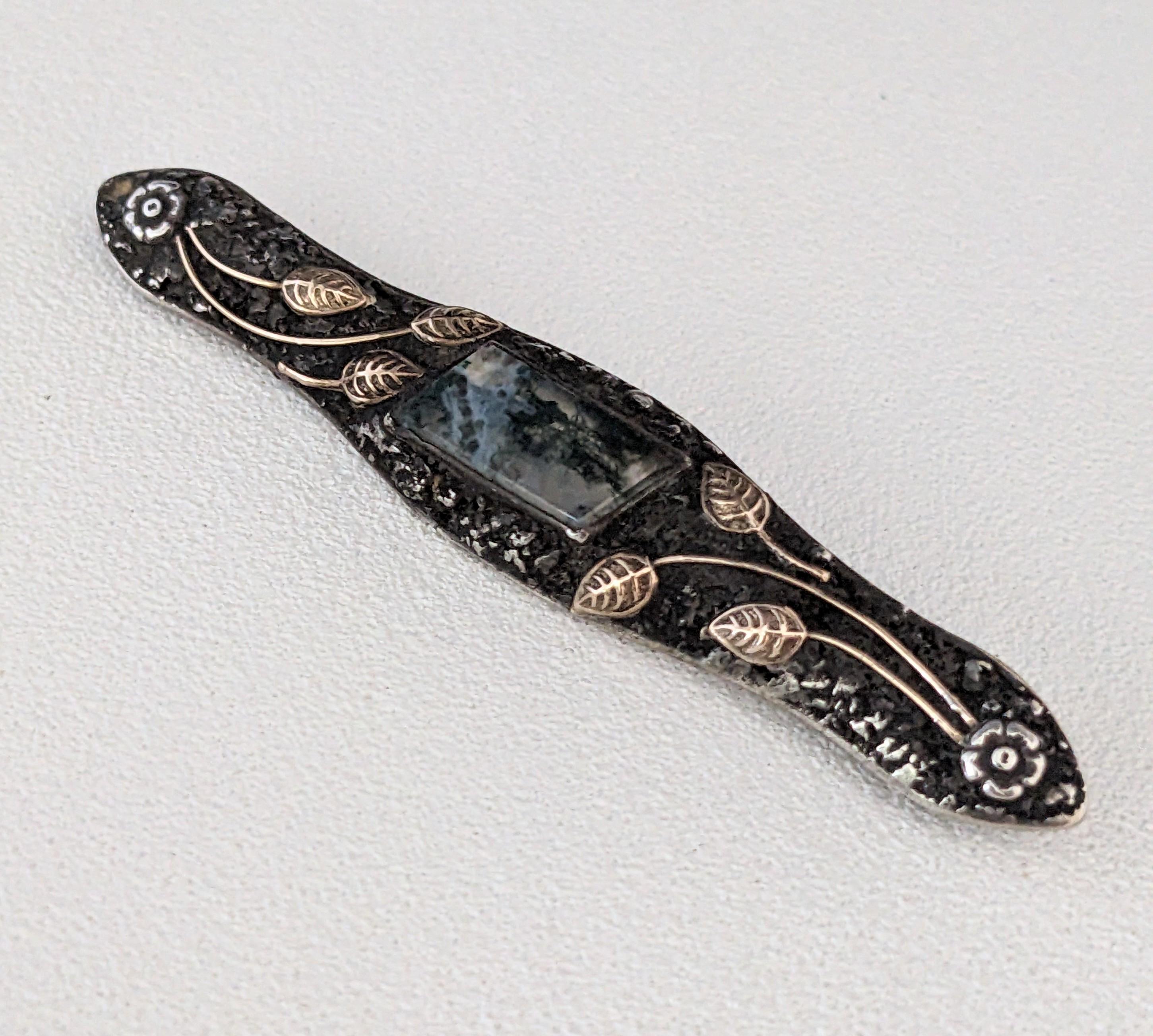 Unusual, elegant American Arts and Crafts Silver and Gold Brooch from 1900's. Textured sterling is overlaid with 14k gold leaves around a trapezoid cut moss agate. 3