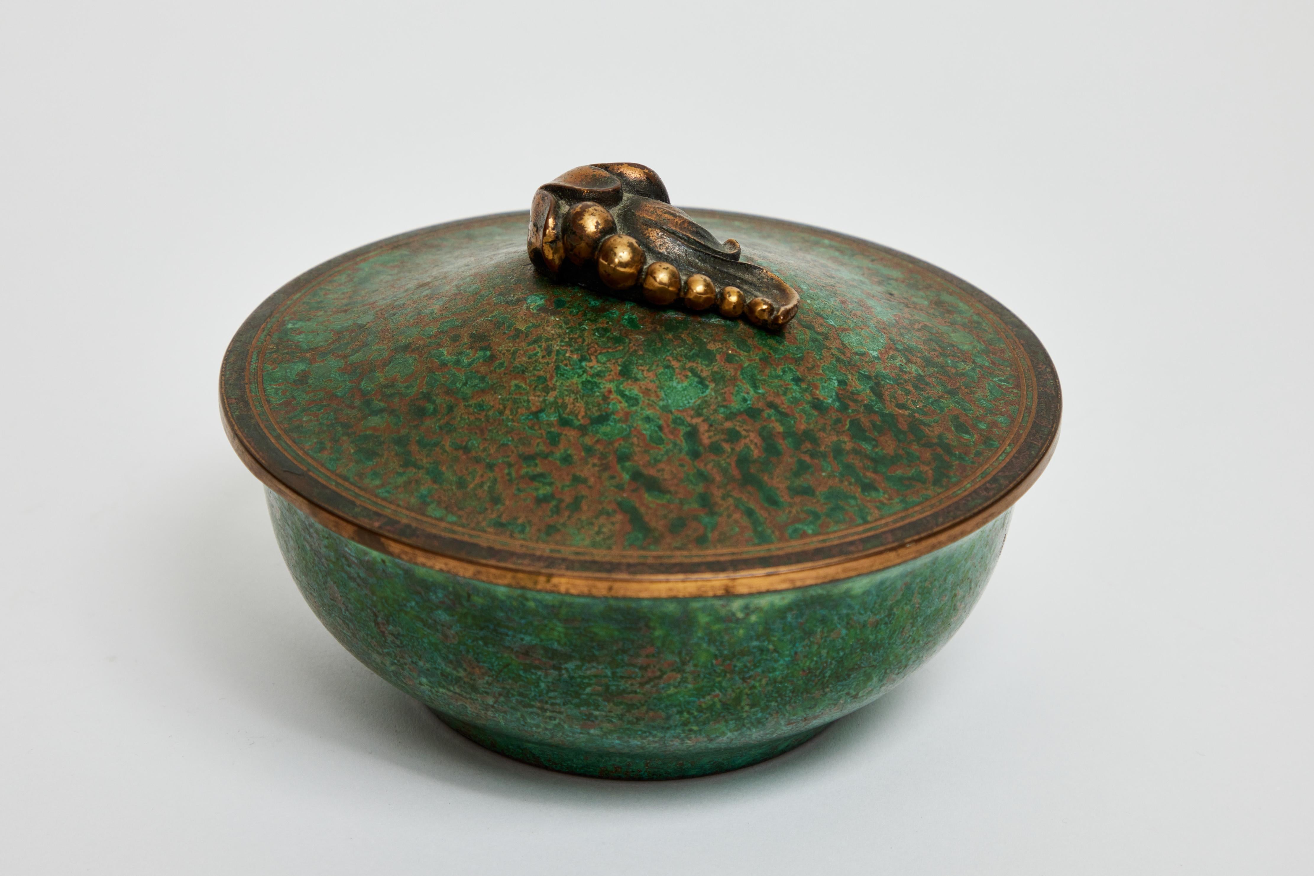 This striking American Arts & Crafts bronze covered dish is hand tooled and finished to an alluring rich verdigris patina, by Carl Sorensen.

Carl Sorensen is noted for his metalwares during the Arts & Crafts Movement of the early 1900's.