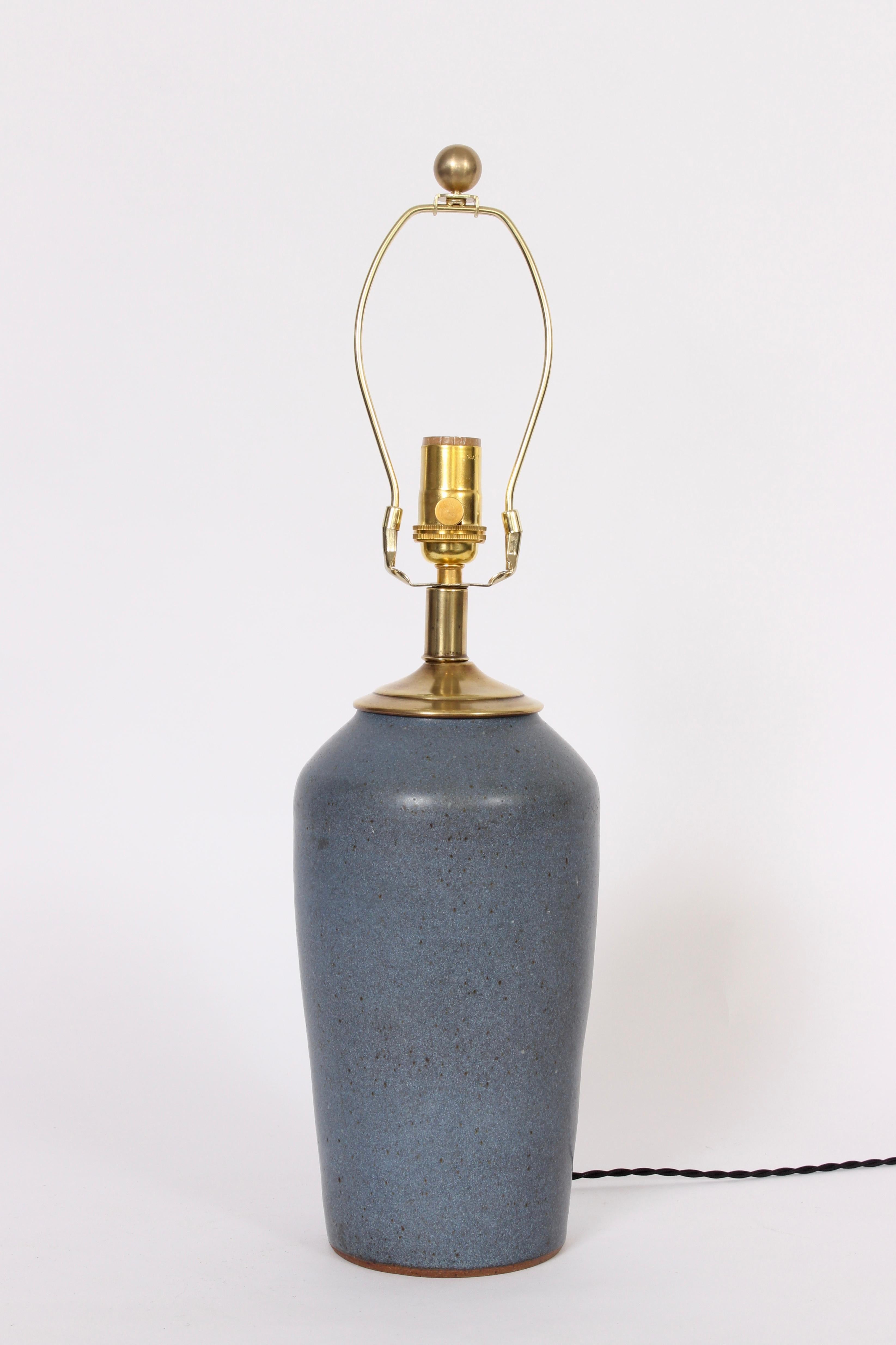 Art Studio matte glazed matte blue stoneware single bedside table lamp, circa 1940s. Featuring a smooth speckled blue bottle form. Shade shown for display only and not for sale (9 H x 11 D top x 13 D bottom). 16 H to top of socket. Ceramic 11 H. 