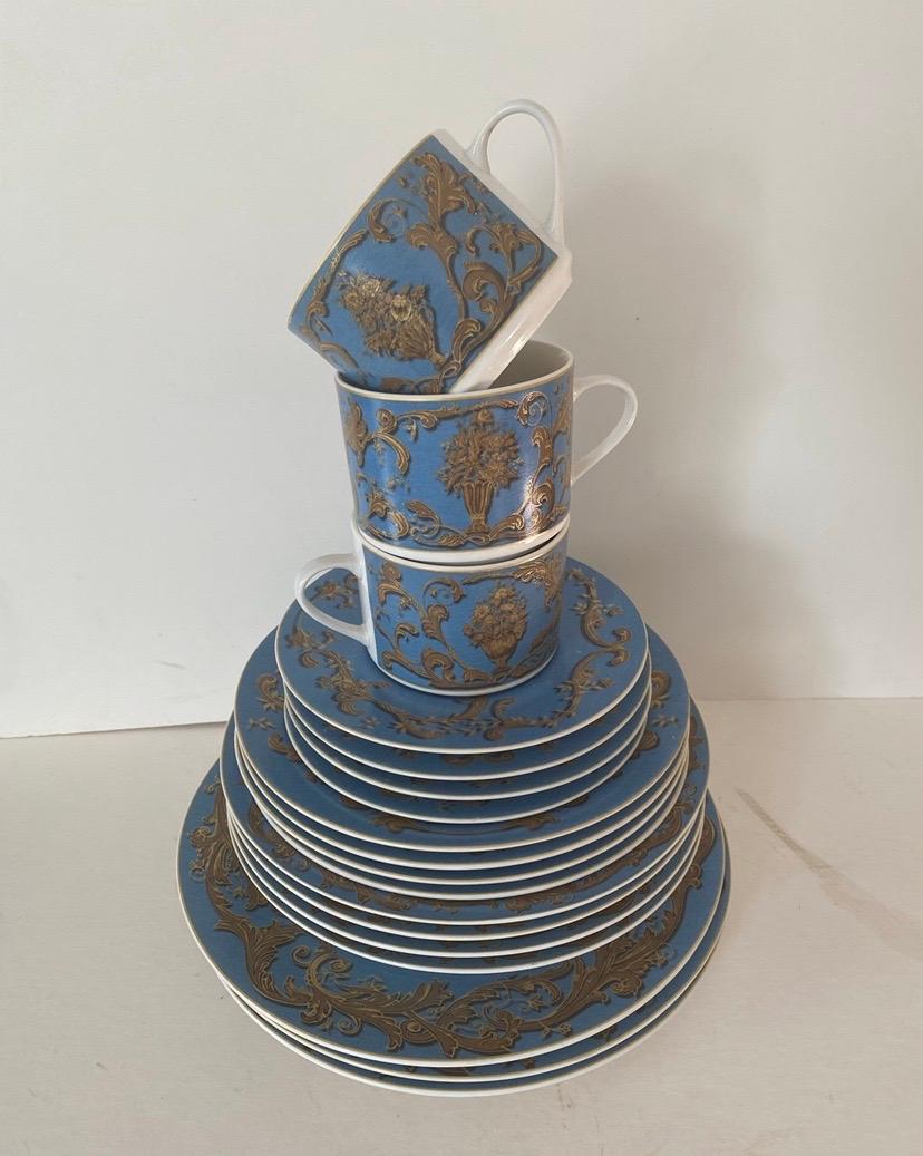 A set of 18 pieces of dinnerware by American Atelier at home in the Blue Jardiniere pattern. 

Features a three-dimensional gold scroll and floral bouquet pattern on a French blue background.

Includes the following 18 pieces:

3 Dinner