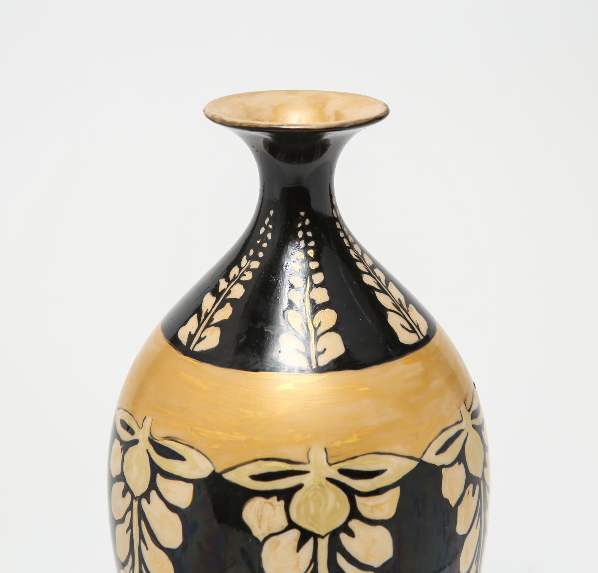 American Belleek vase in black with hand-painted gold and cream wisteria motif and a 1894-1906 mark on the underside, from the Walter Scott Lenox Ceramic Art Company, Trenton, NJ. The piece has a slight hairline crack on the lip.